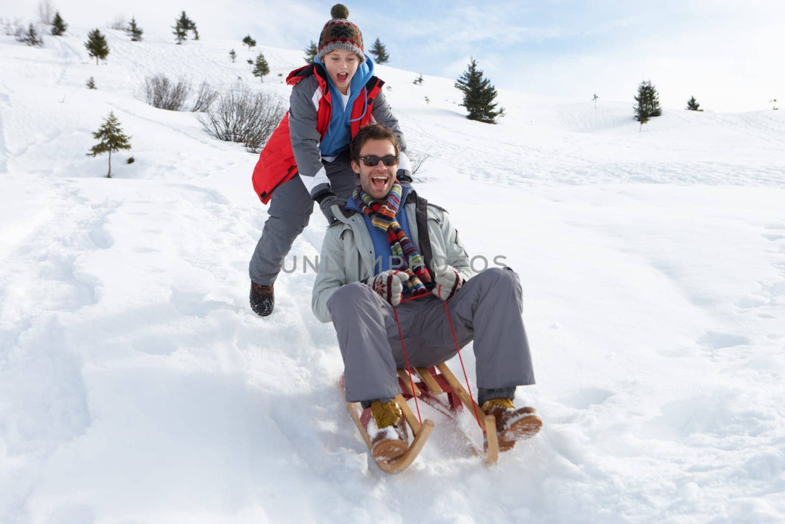 Young Father And Son Sledding