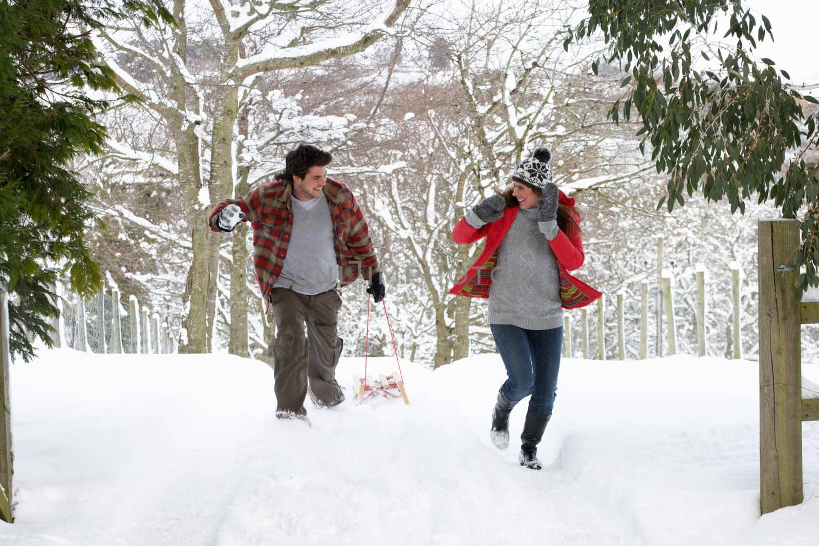 Young couple having snowball fight