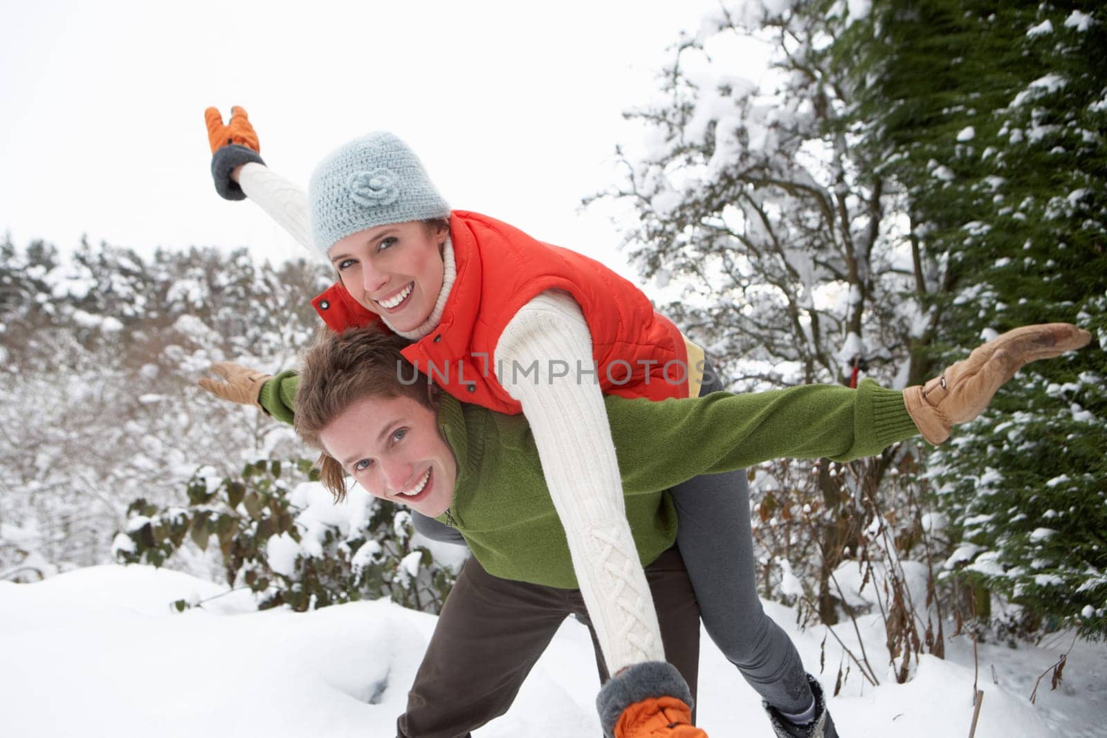 Young couple having fun in snow