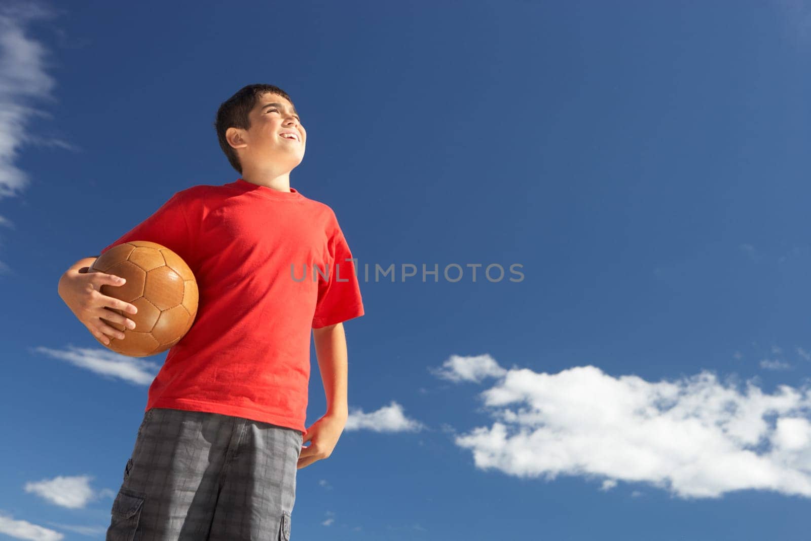 Teenage boy holding football