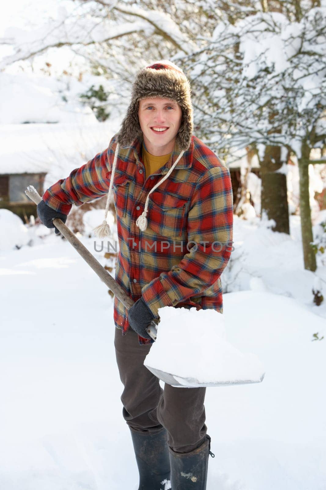 Young man clearing snow