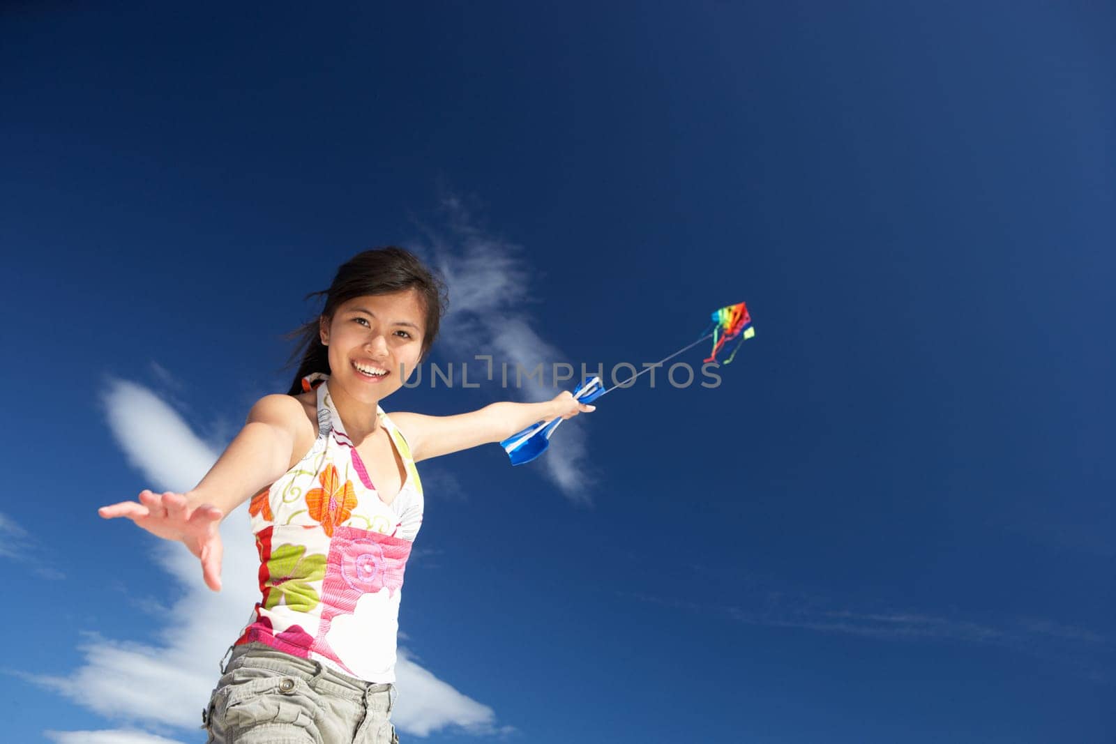 Teenage girl flying a kite