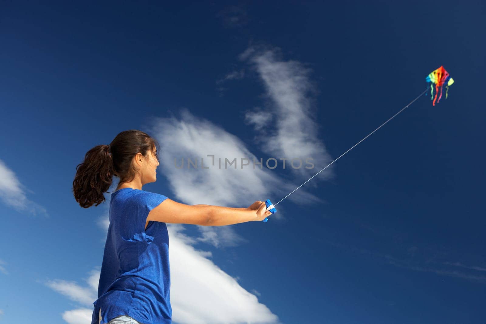 Teenage girl flying a kite