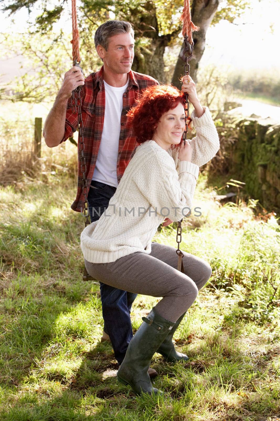 Couple with country garden swing