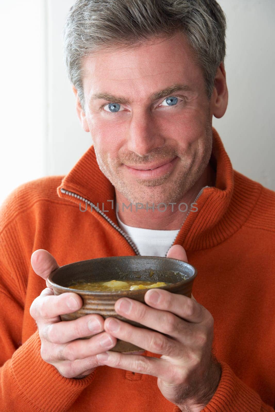 Man holding bowl of soup