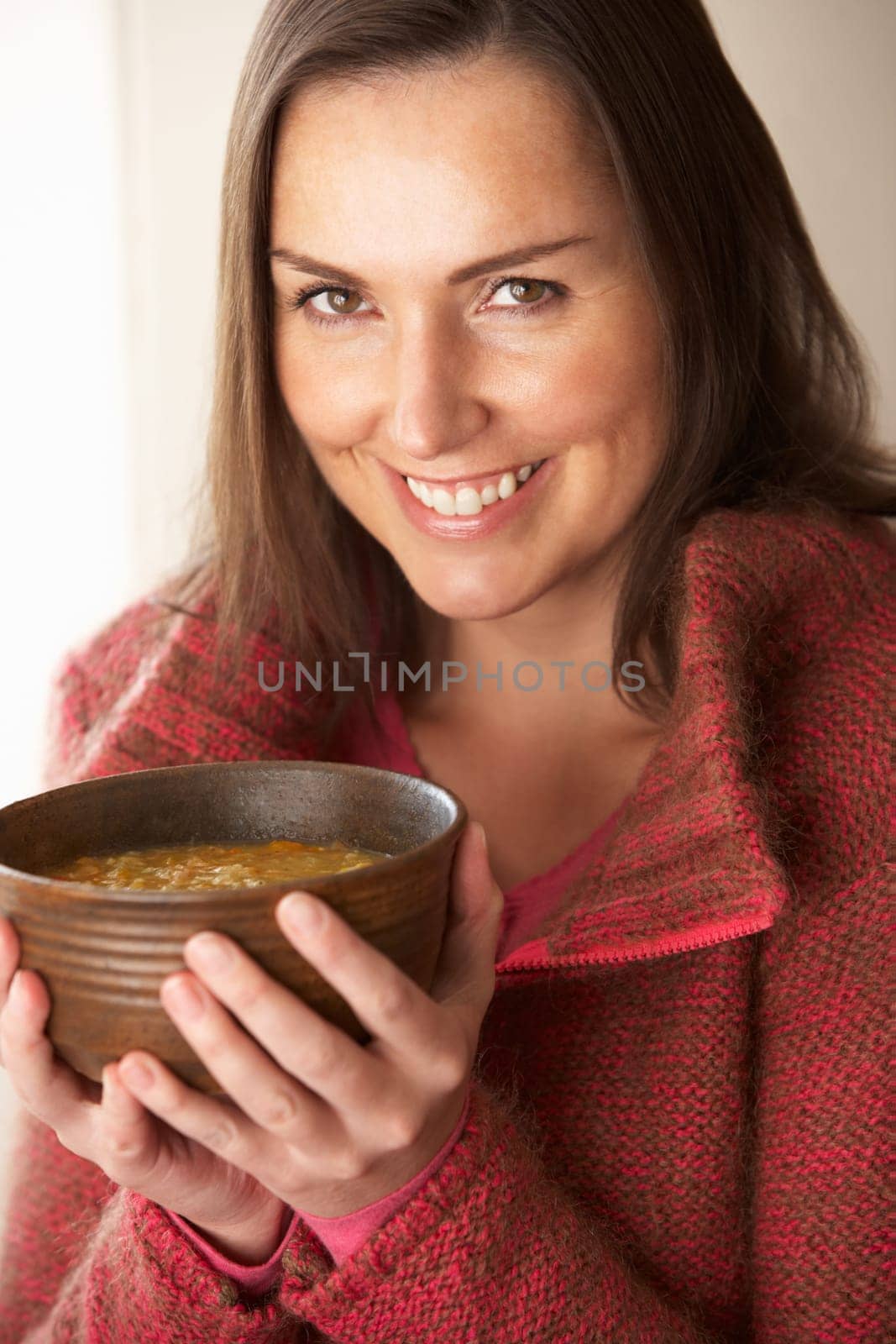 Woman holding bowl of soup