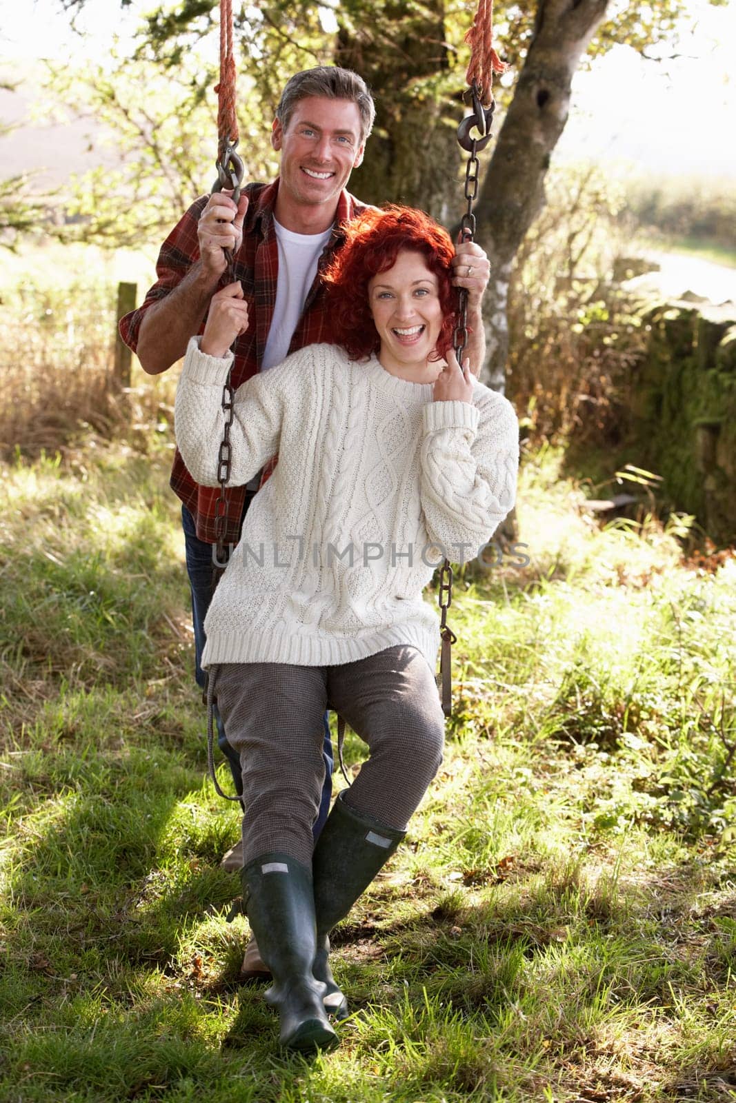 Couple with country garden swing