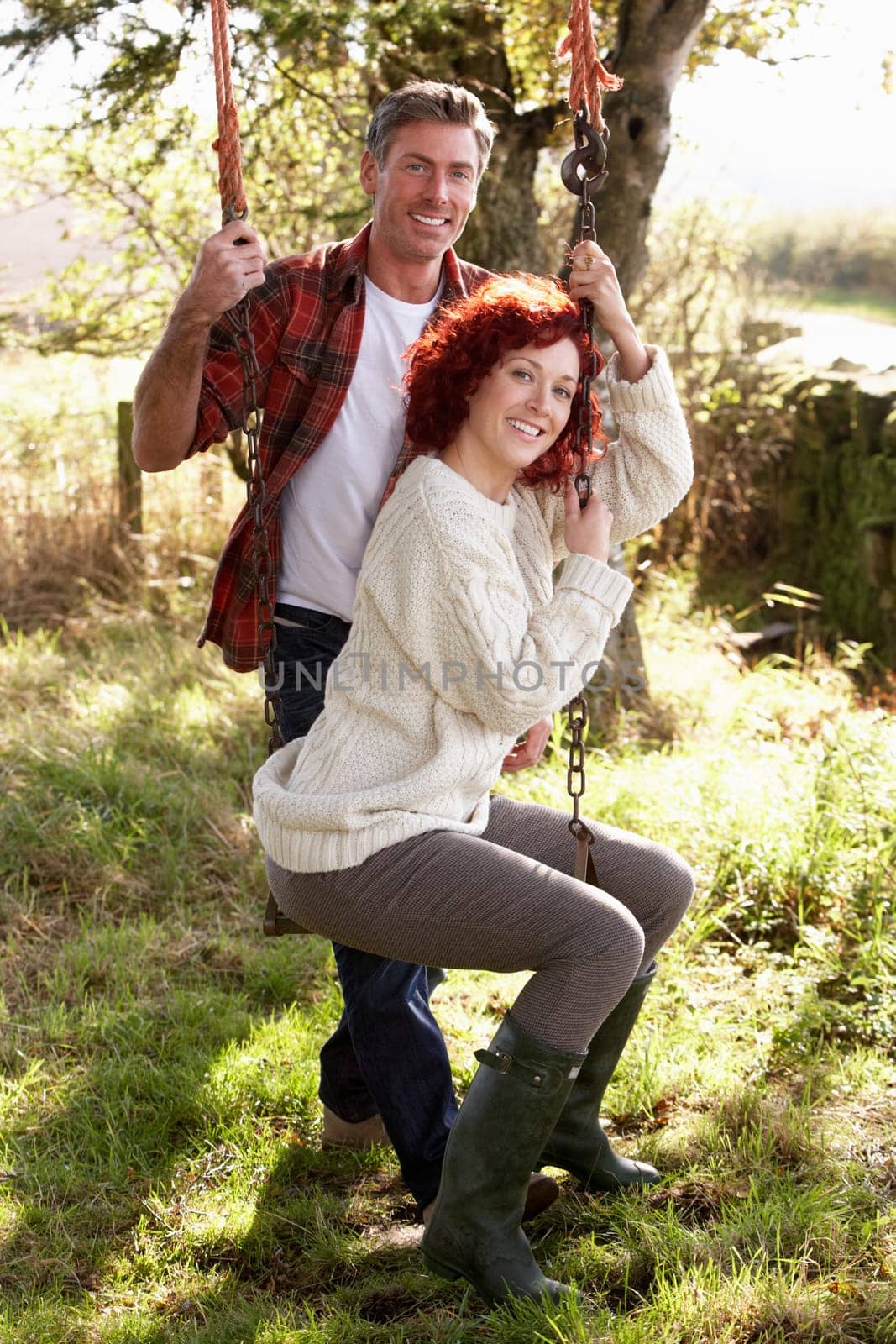 Couple with country garden swing