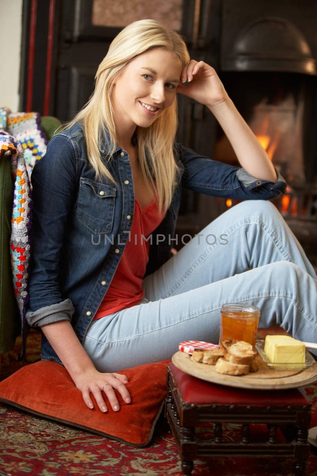Young woman making toast on open fire