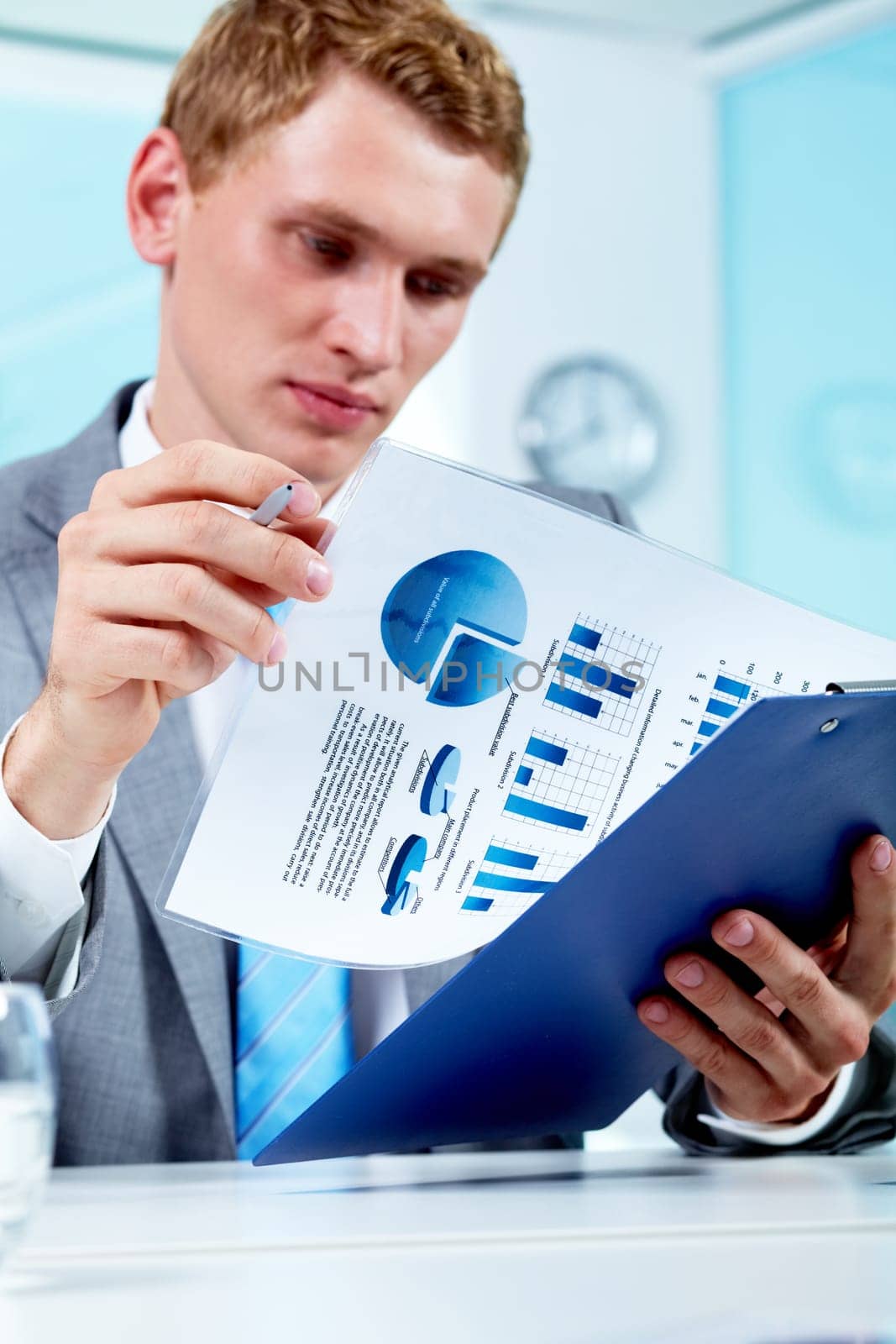Portrait of a serious manager holding document