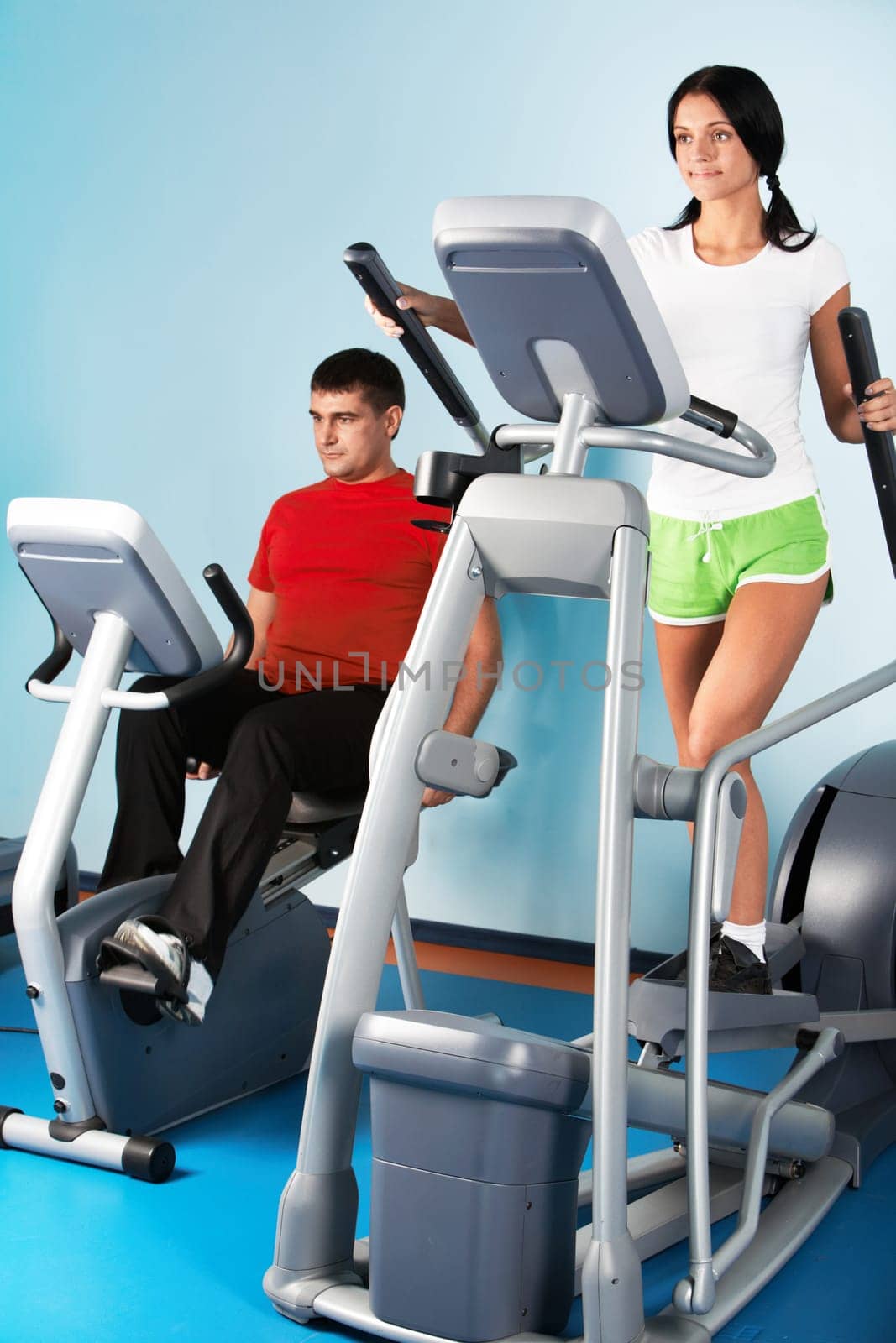 Image of beautiful girl on training apparatus in sport club
