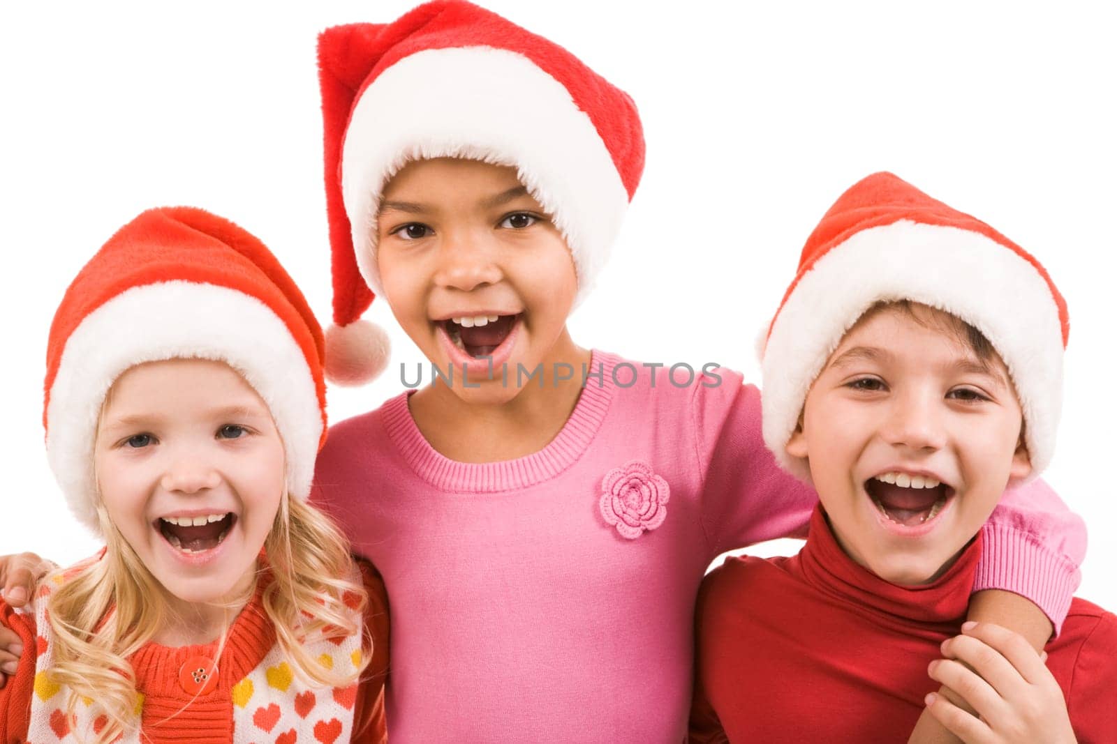 Photo of happy friends in Santa caps laughing over white background