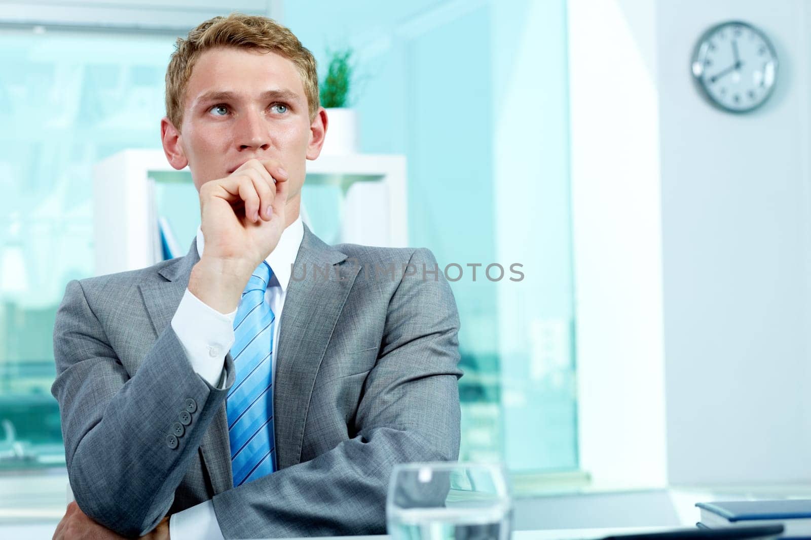 Portrait of a pensive businessman with hand by his mouth