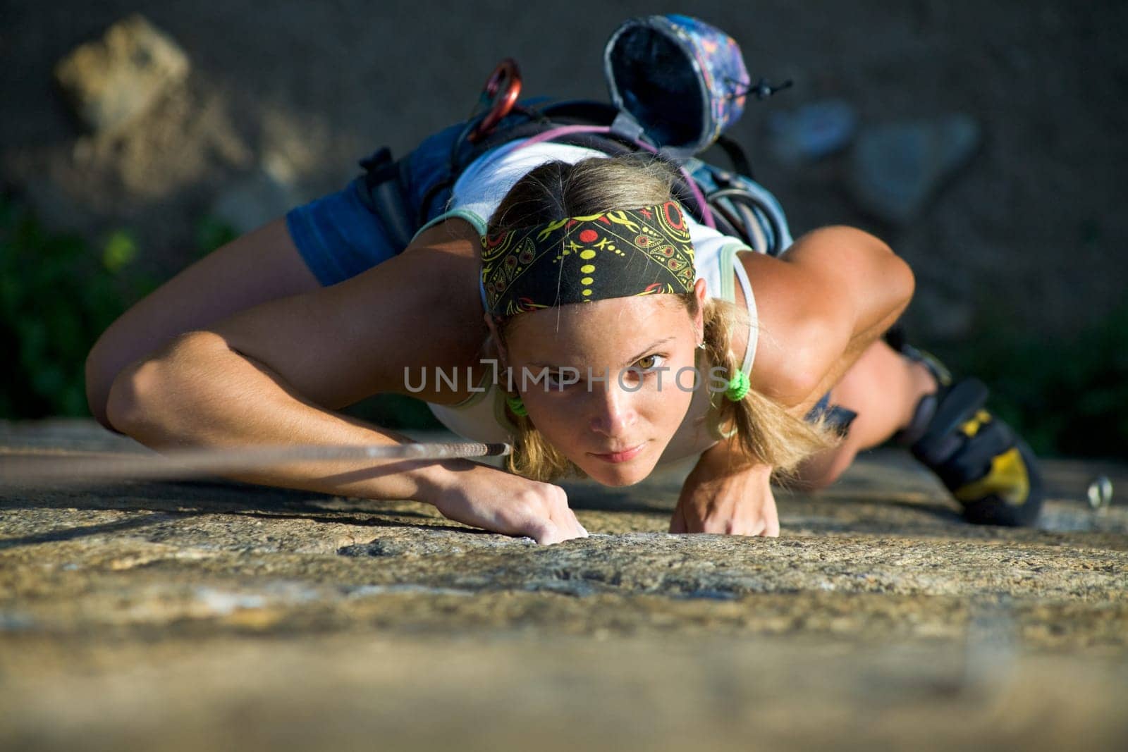 Vertical image of woman doing exercise on the mountain