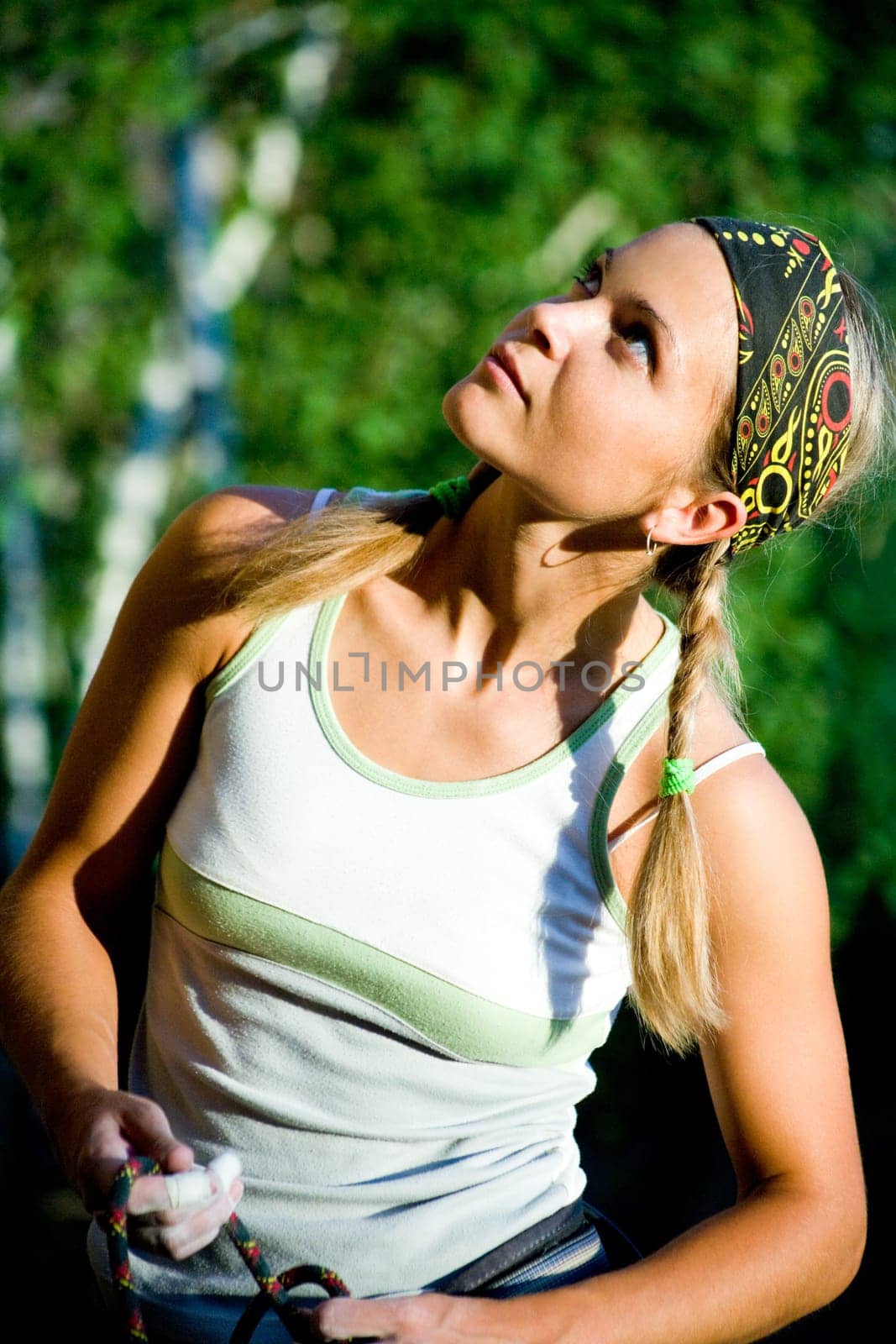 Image of young girl looking in aside on the background of trees
