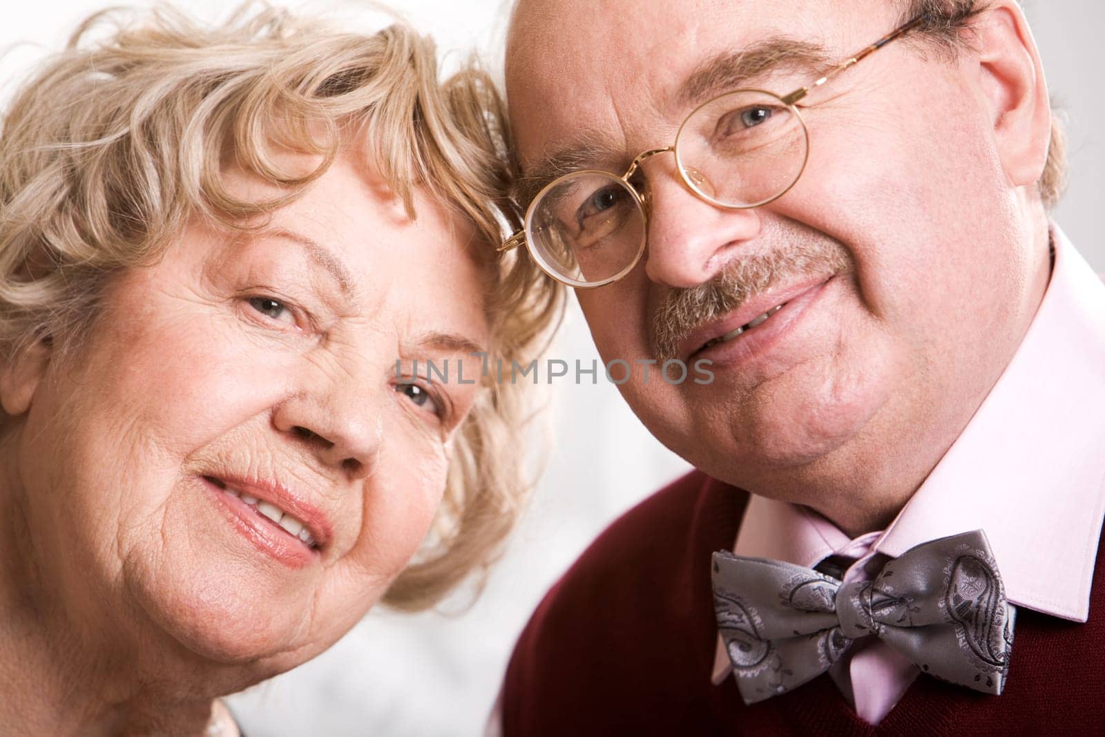 Two smart elderly people looking at camera during their jubilee