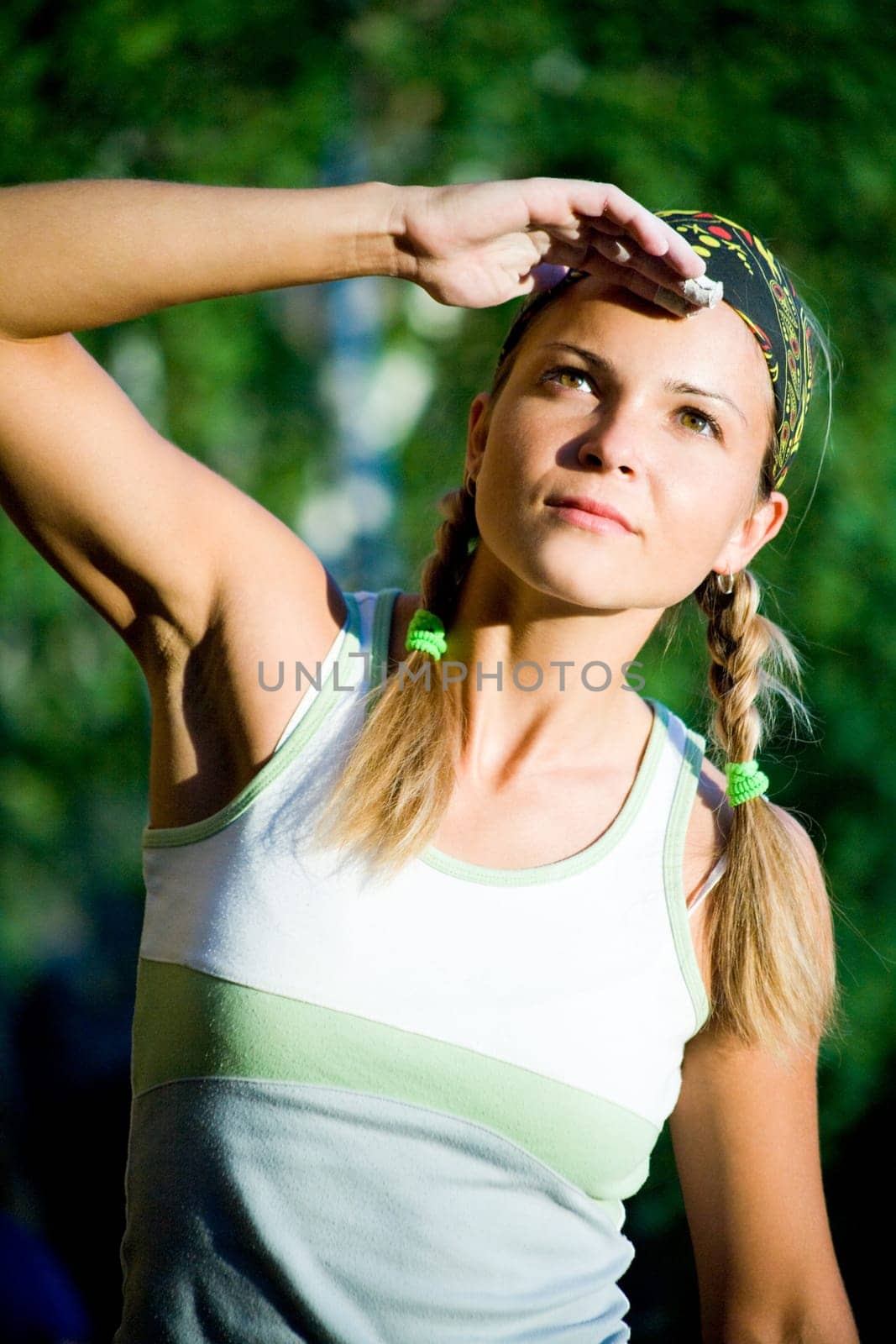 Portrait of young lady in t-shirt and head bandage looking in aside