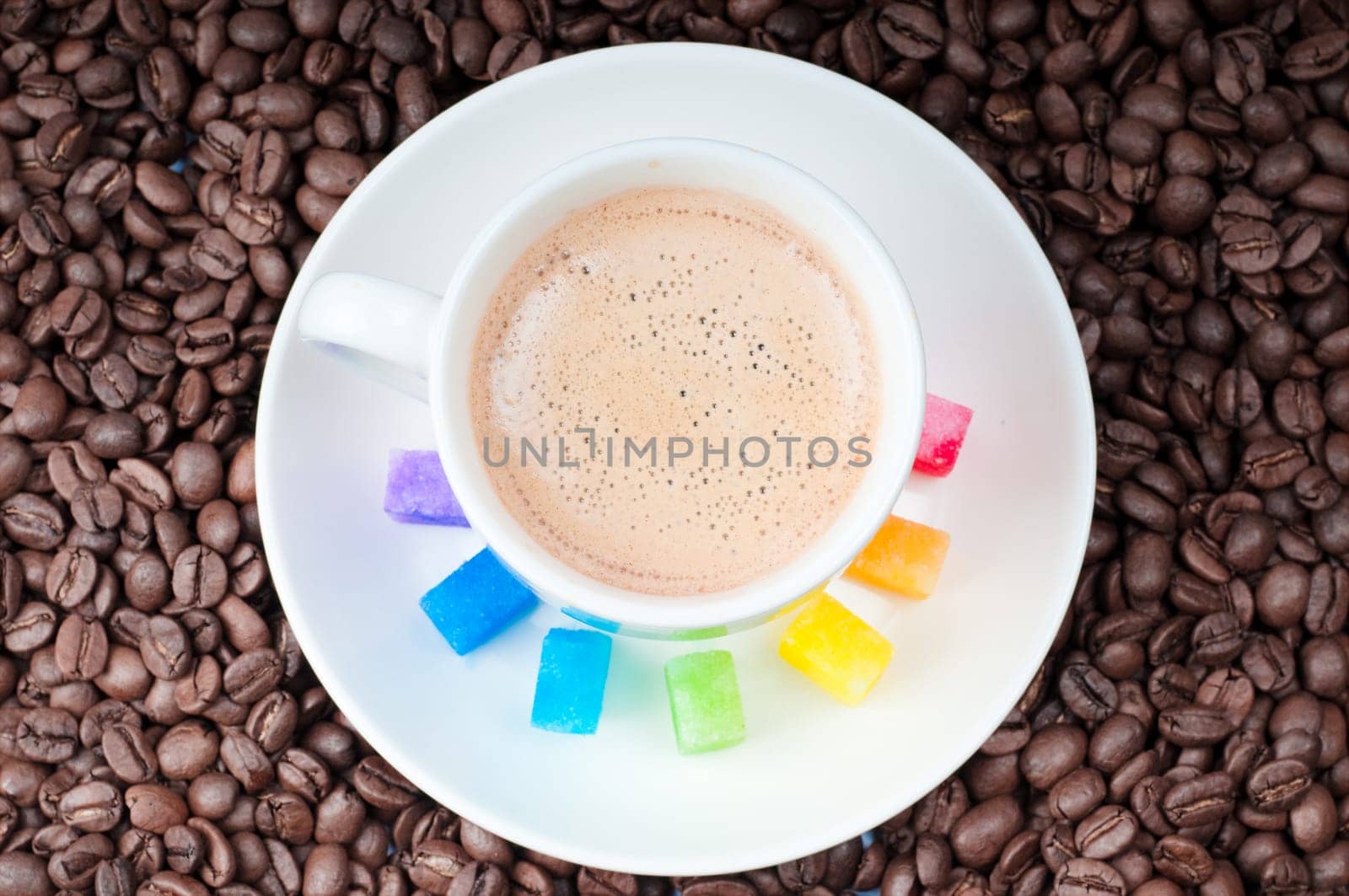 Shot of multicolored slabs of shugar and cup of coffee