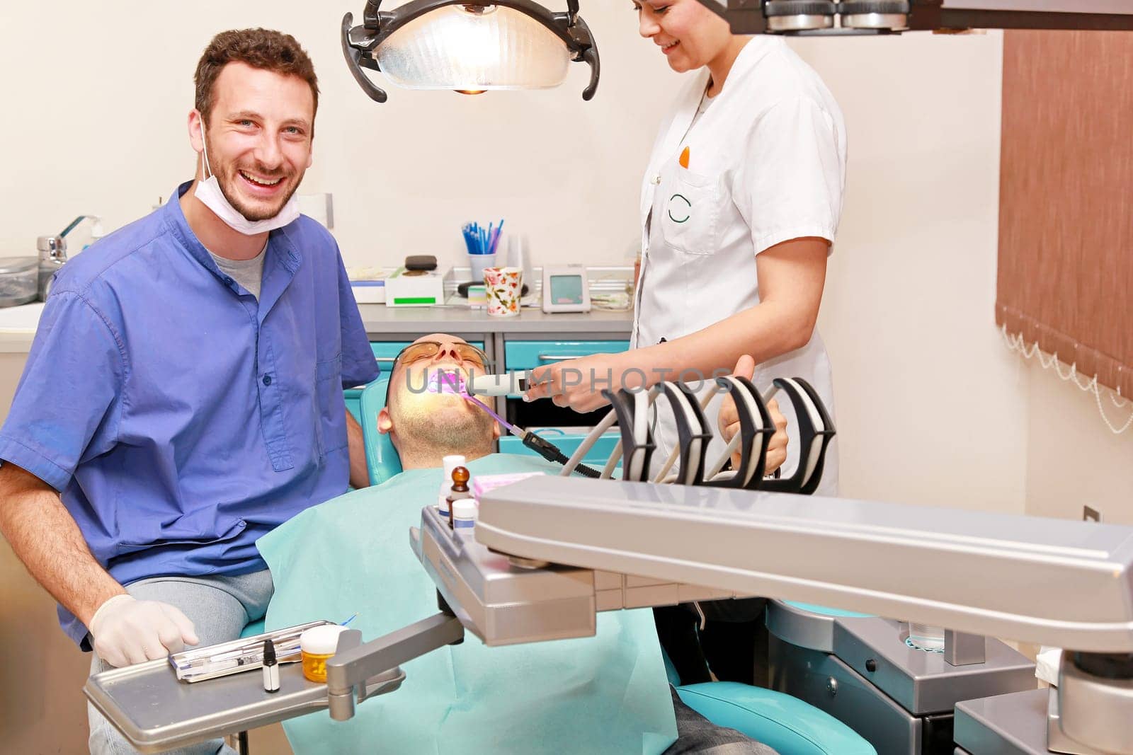 Smiley doctor and patient in dentist office