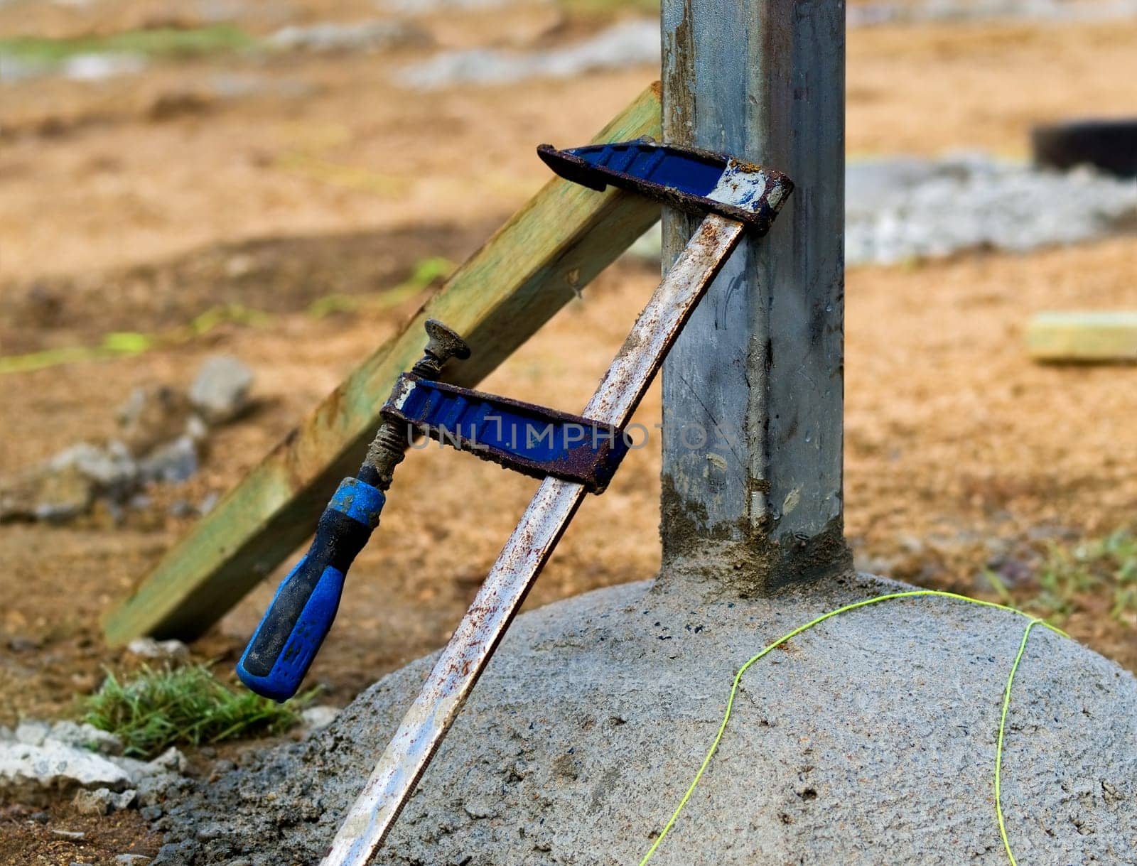 building site concrete footings steel stump and F clamp