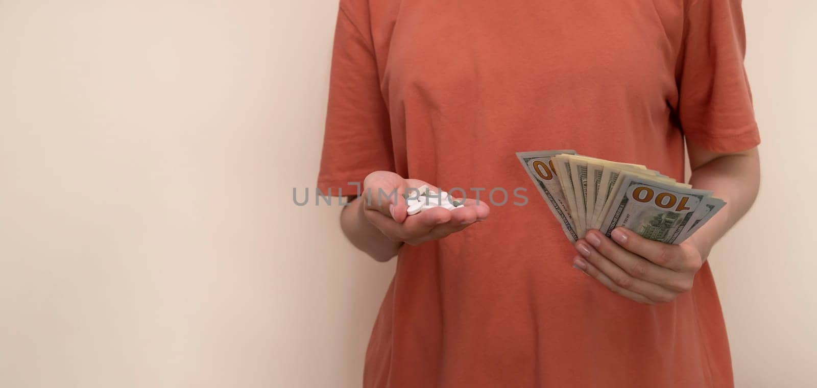 Design White Cropped Woman Holds Heap Of Pills, Tablets, Supplement And Money, Wad Of Dollar Cash. Horizontal Plane. Space For Text. High quality photo