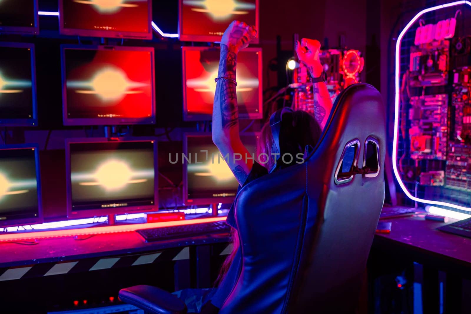 Winning. Happy Gamer young plays online video games computer she raises hands to wins tournament, young woman in gaming headphones playing video game online at home feel excited, E-Sport concept