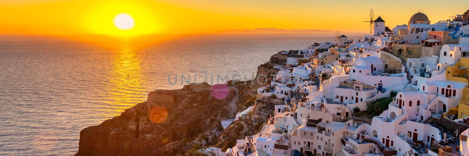 White churches an blue domes by the ocean of Oia Santorini Greece, traditional Greek village by fokkebok