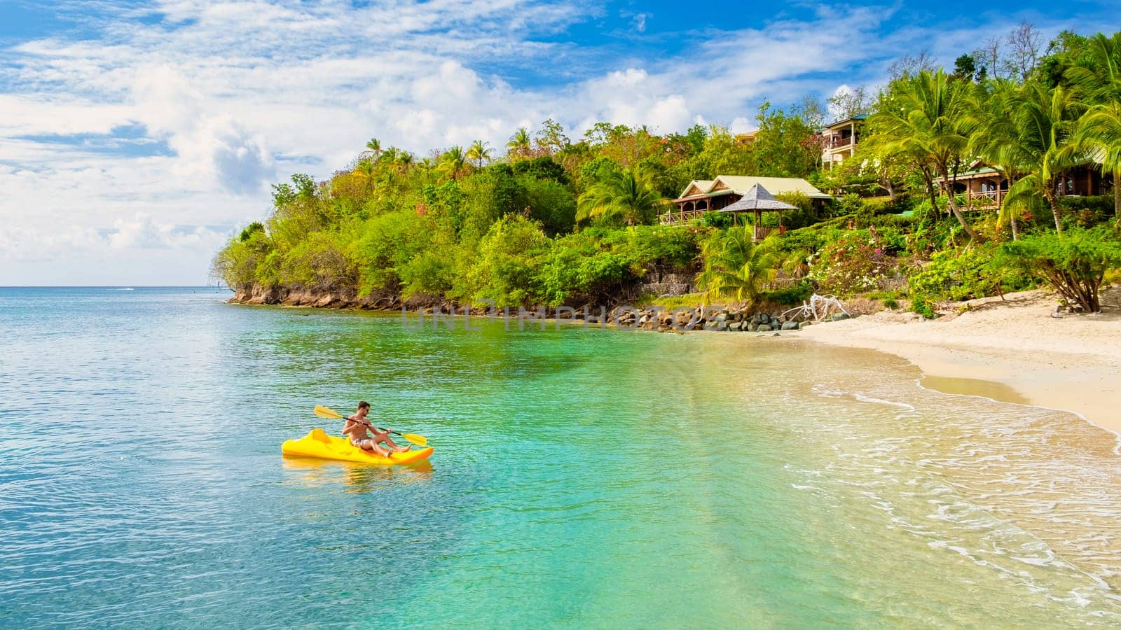 young men in kayak at a tropical island in the Caribbean sea, St Lucia or Saint Lucia by fokkebok