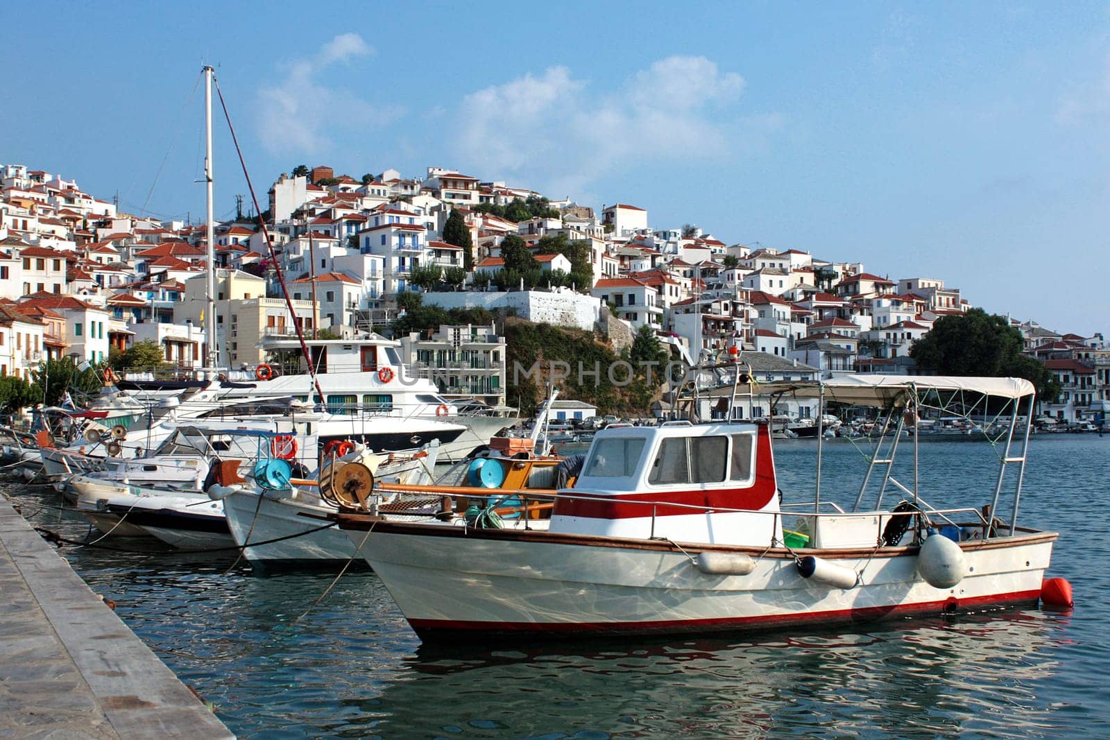 Boats in the port of Skopelos a Greek island and houses, in Sporades. Landscape