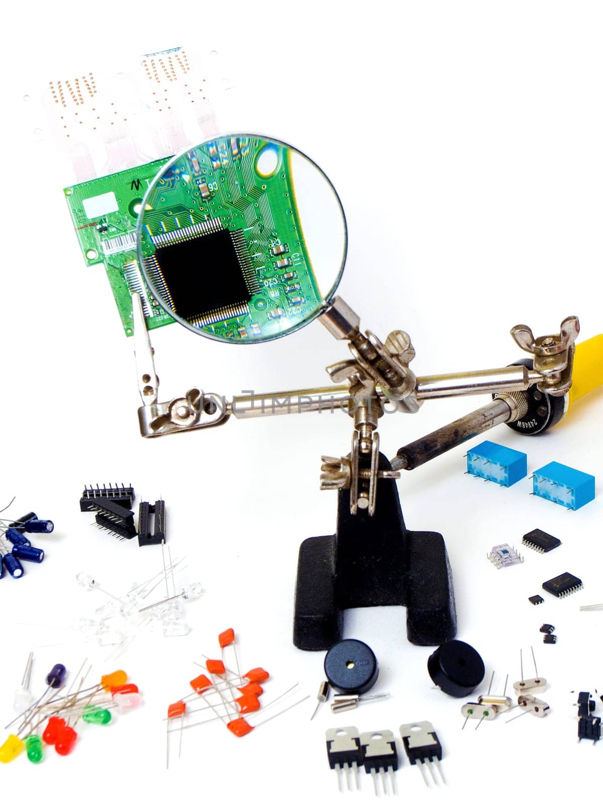 Repairing a green pcb board and electronic components, isolated on white background