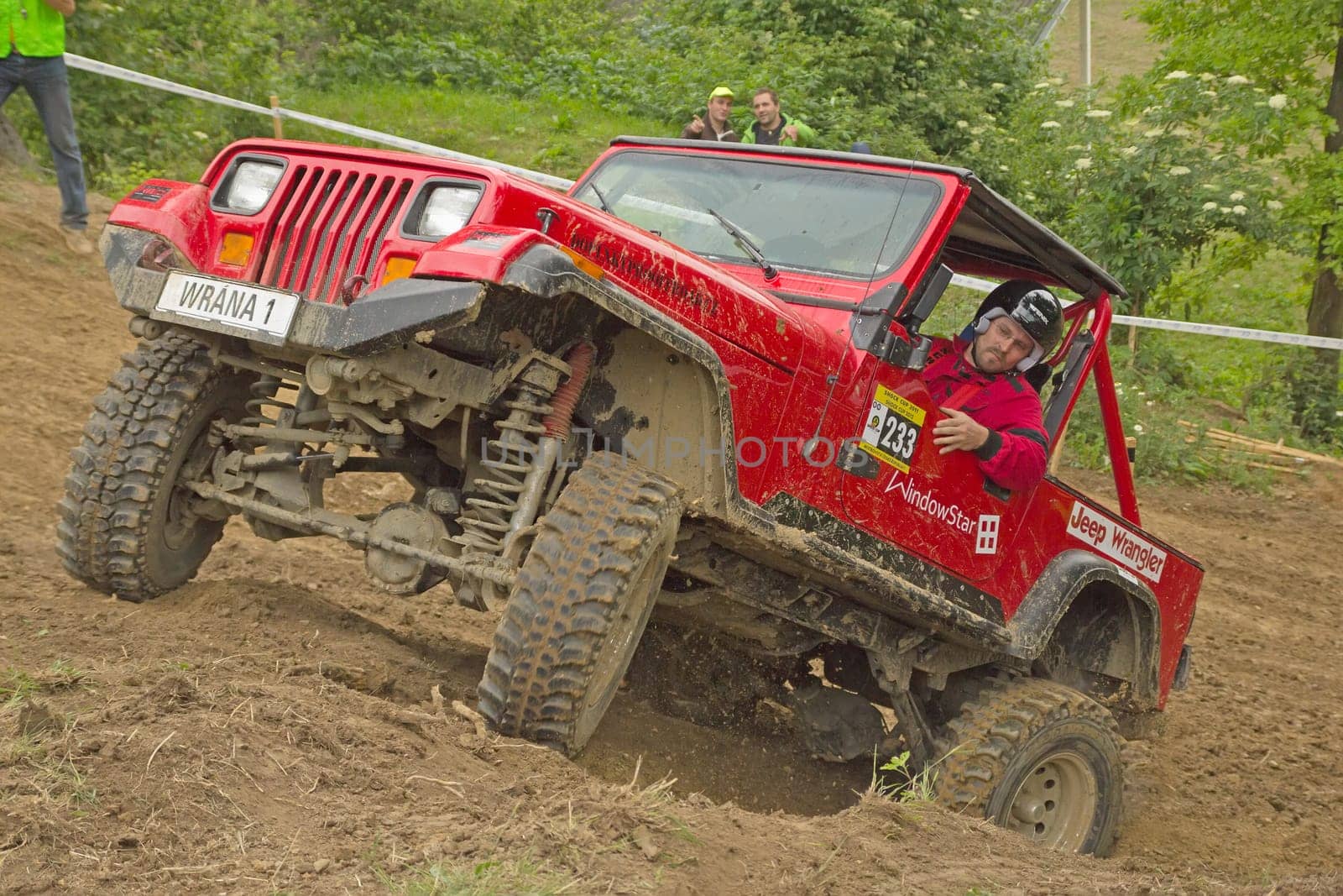 MOHELNICE, CZECH REPUBLIC - JUNE 10. Unidentified racer at red off-road car leaves steep slope in the "SHOCK CUP Trial 2012"" on June 10, 2012 in the town of Mohelnice, Czech Republic."