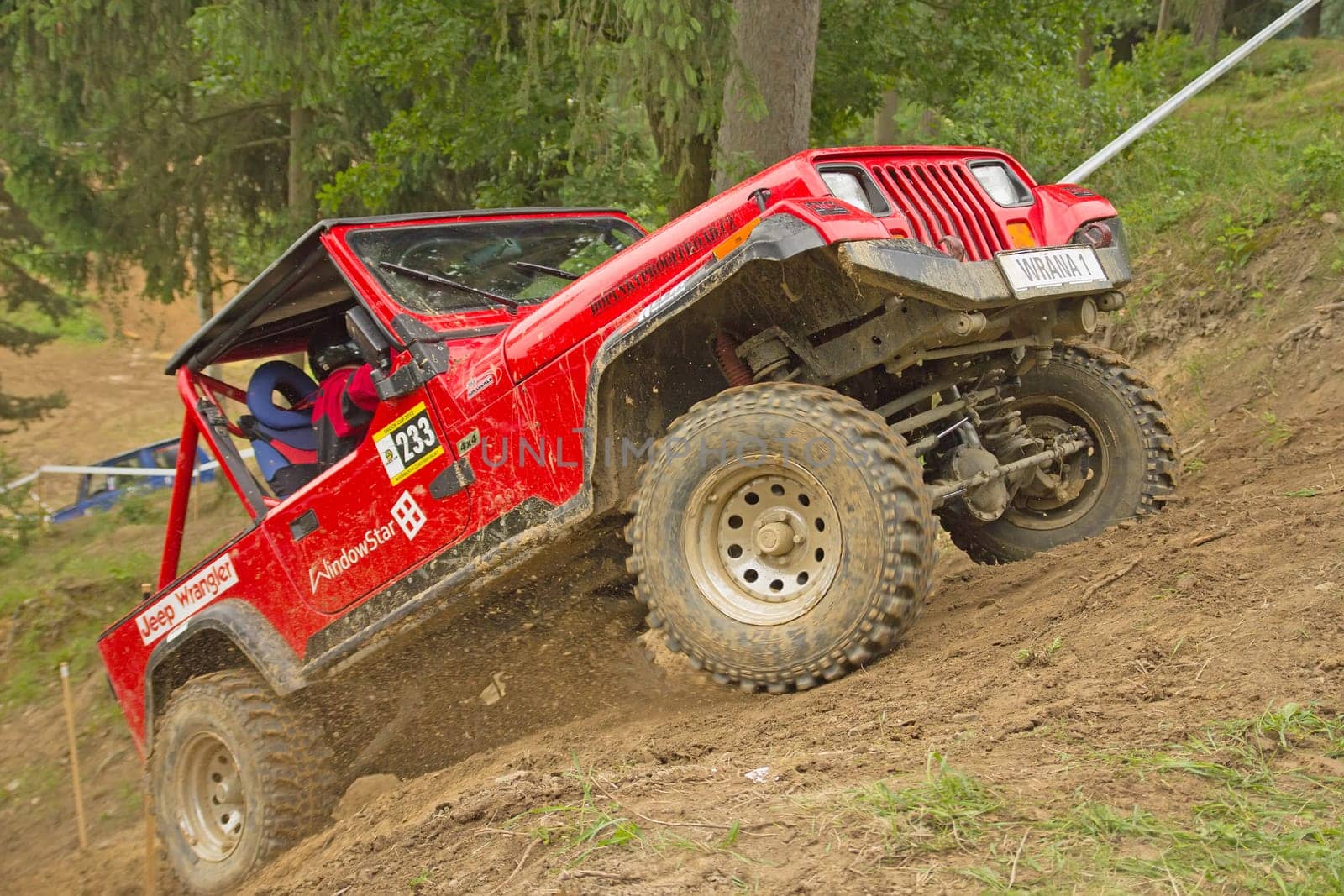 MOHELNICE, CZECH REPUBLIC - JUNE 10. Unidentified racer at red off-road car leaves steep slope in the "SHOCK CUP Trial 2012"" on June 10, 2012 in the town of Mohelnice, Czech Republic."