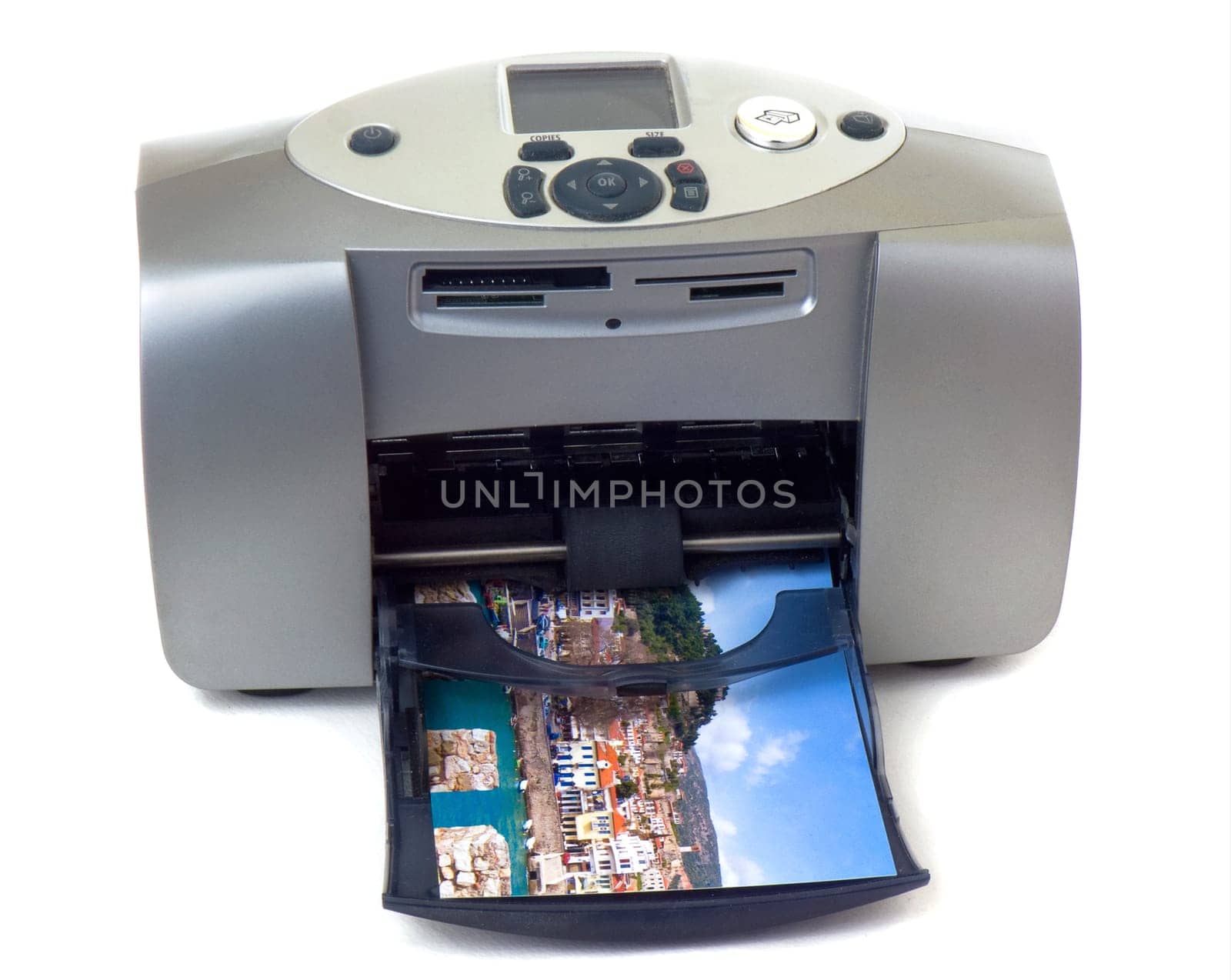 A small gray inkjet printer is printing a photo, isolated on white background