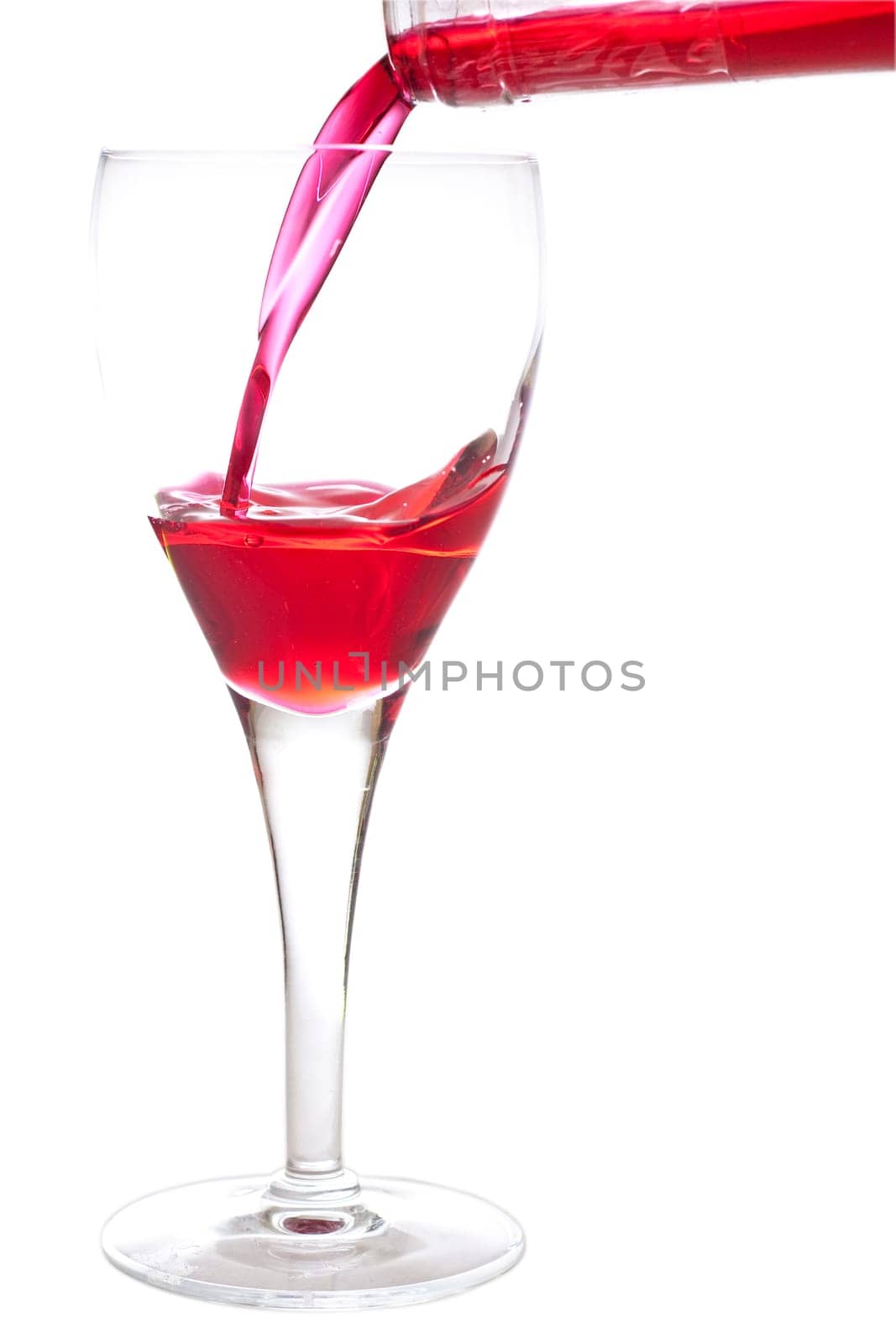 Filling a glass with red cherry liquer, drink, on white background