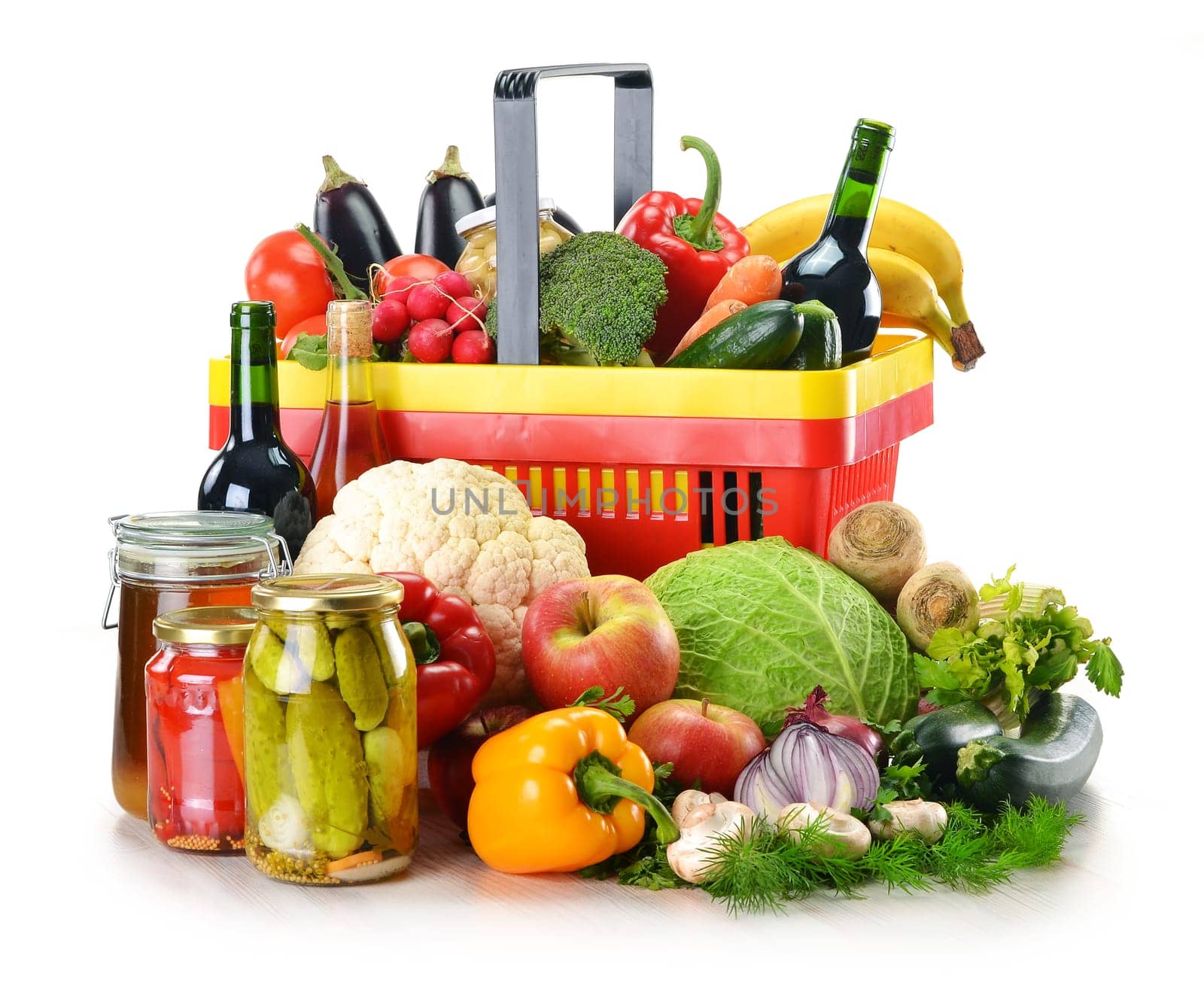 Composition with plastic shopping basket and grocery isolated on white