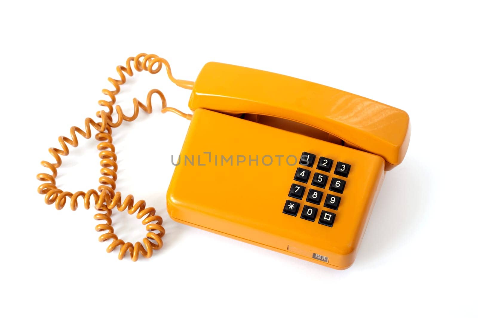 Old orange telephone isolated on white background