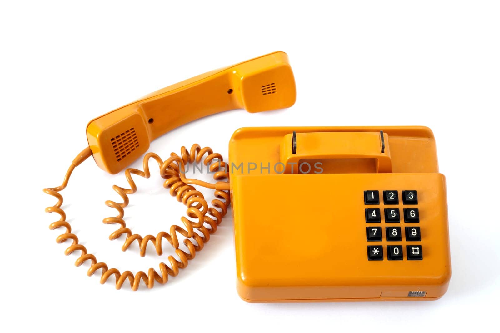 Old orange telephone isolated on white background