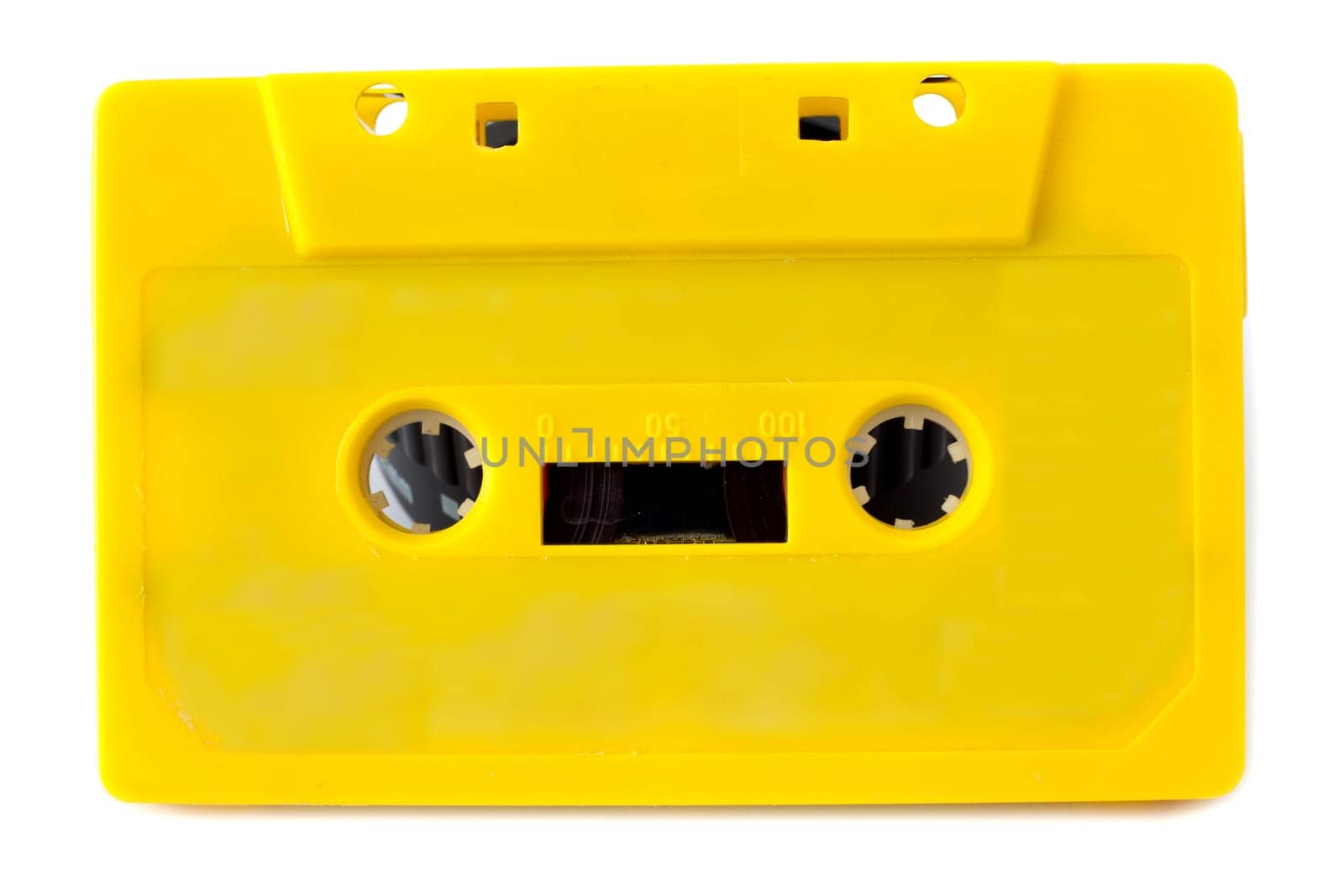 Yellow audio cassette on white background