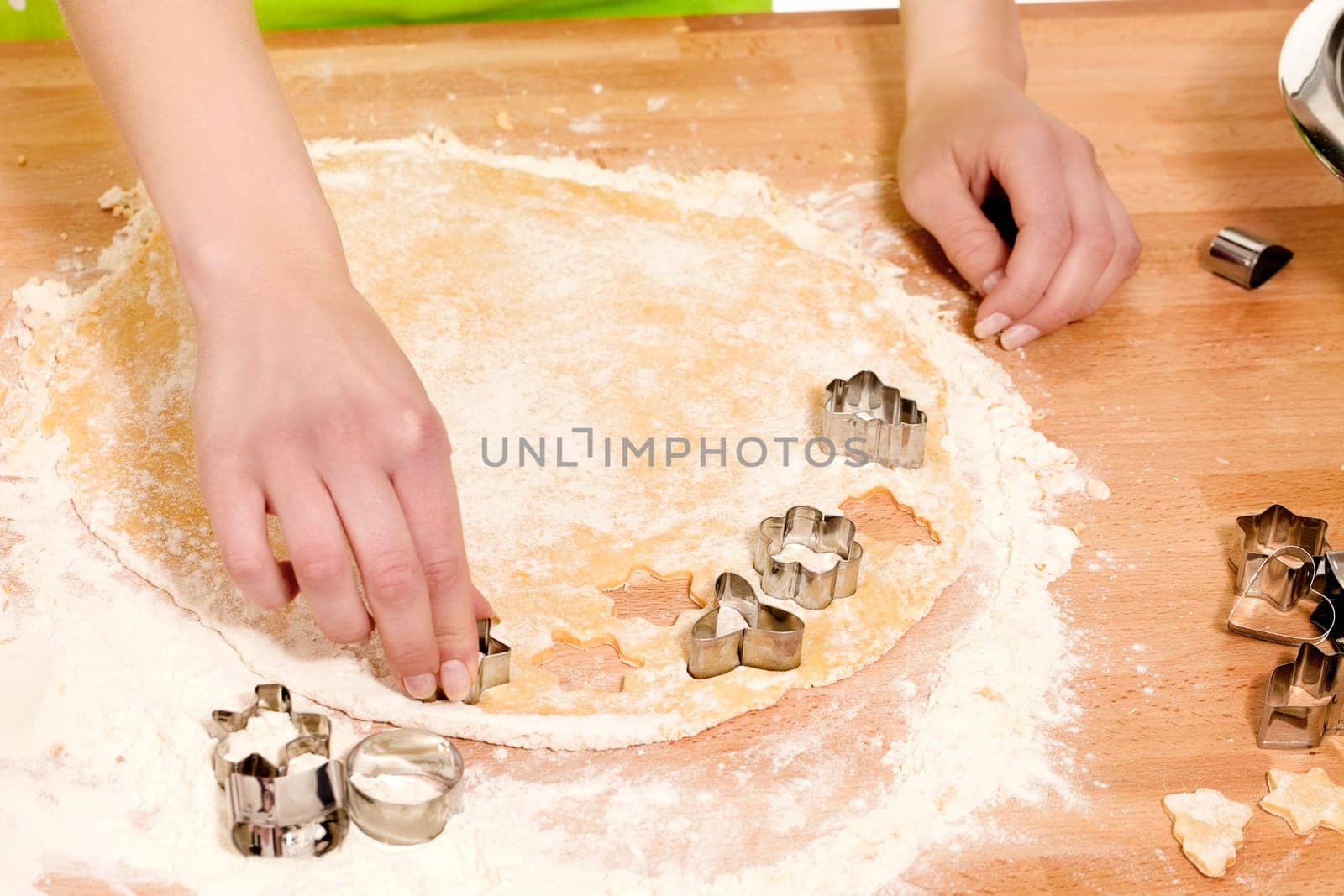 Hands cutting out dough