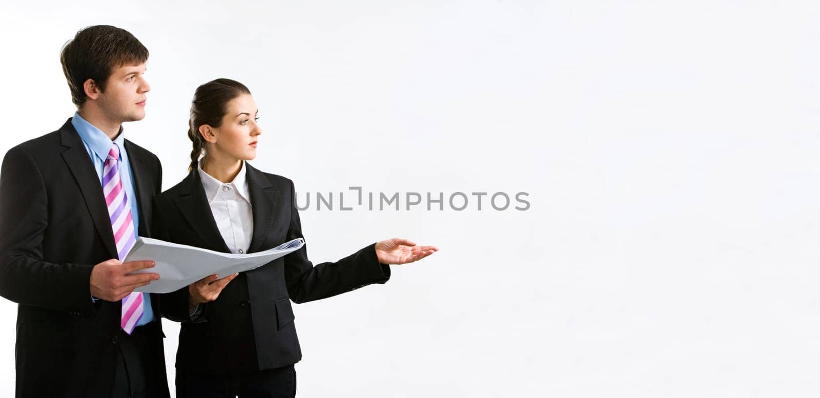Image of two business people holding a document and looking at something