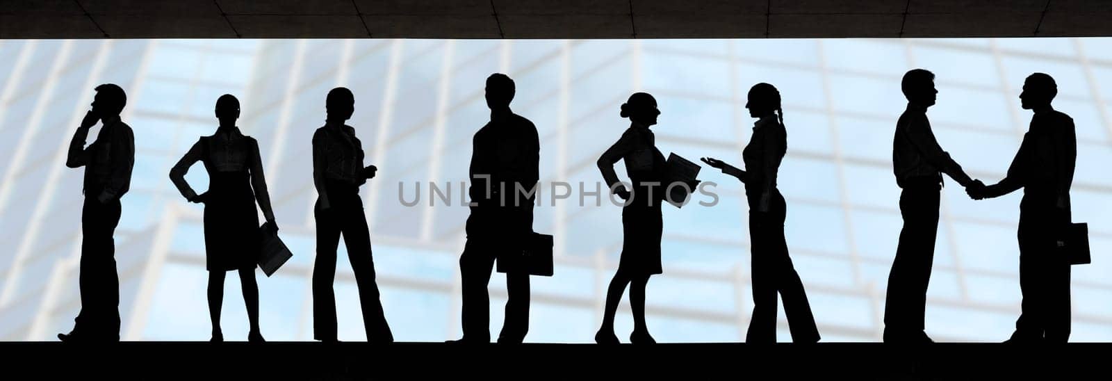 Several silhouettes of businesspeople interacting over blue background