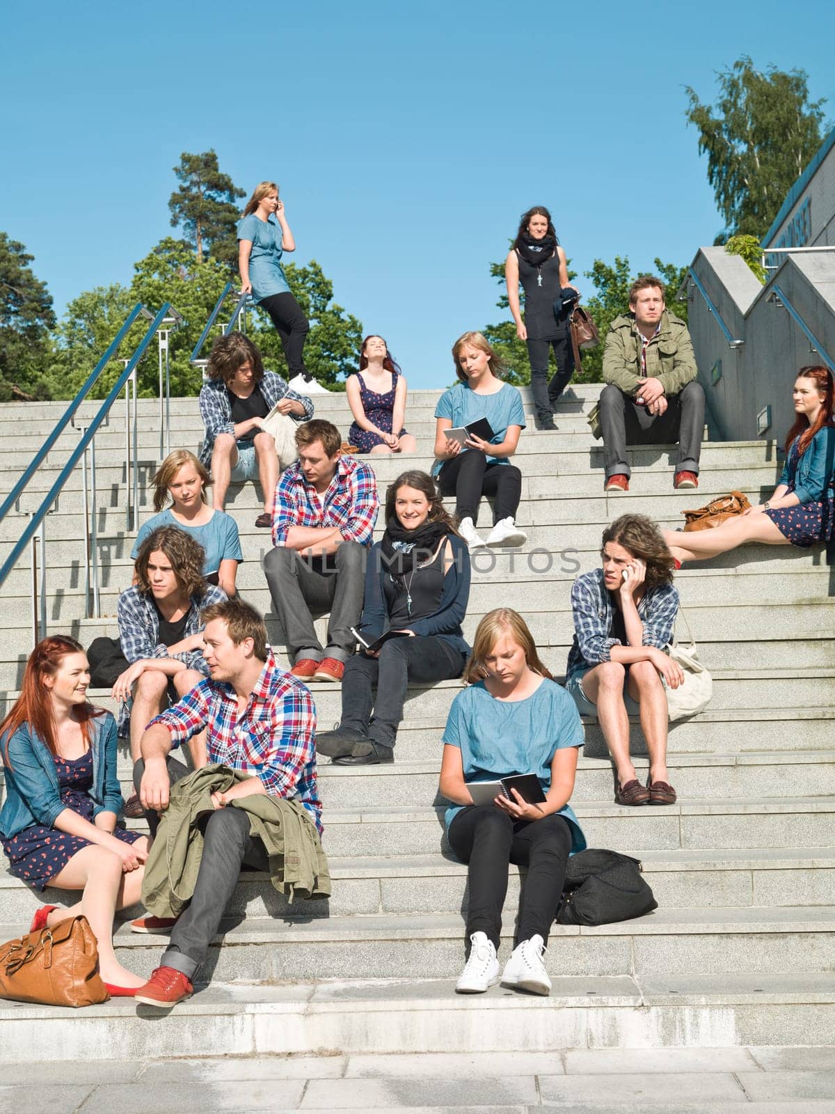 Large group of people sitting in the stairs