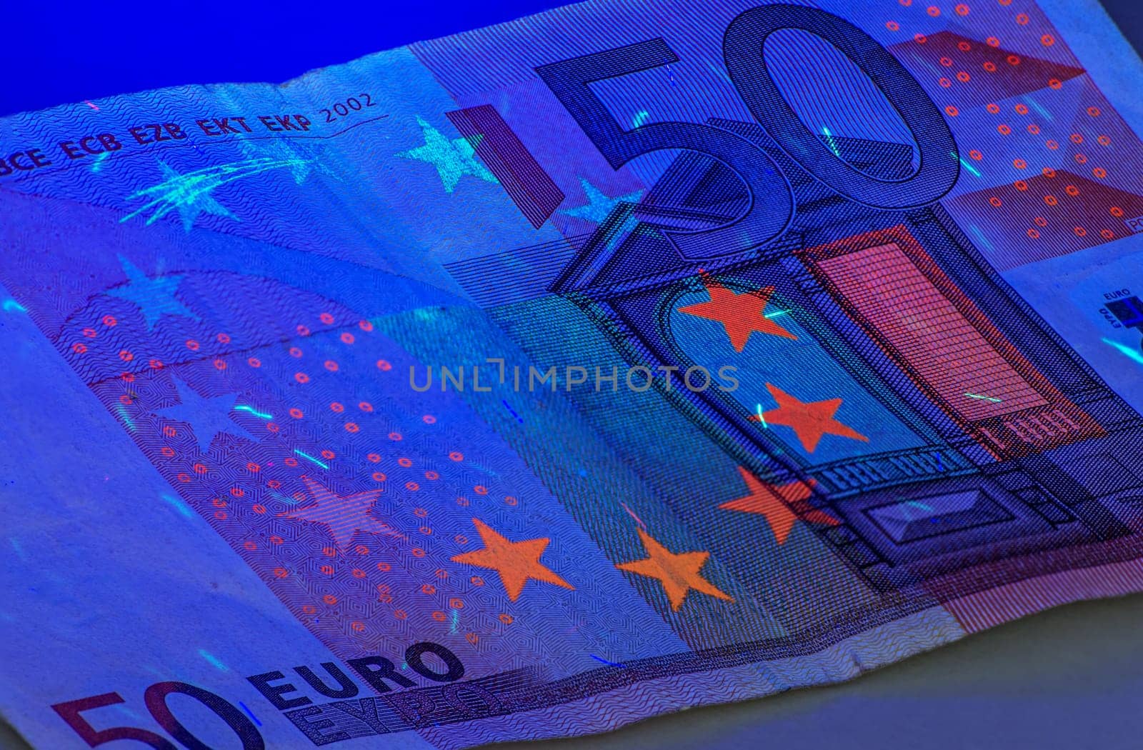 Fifty euro note under ultraviolet light