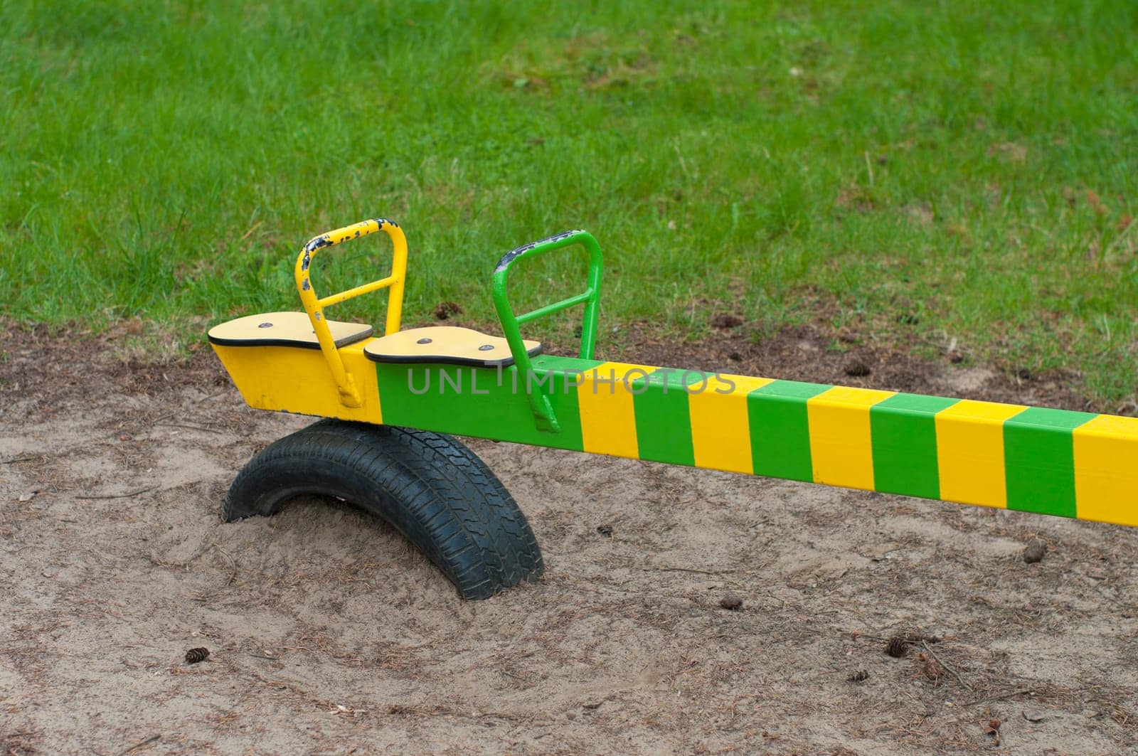 detail of a green with yellow see saw