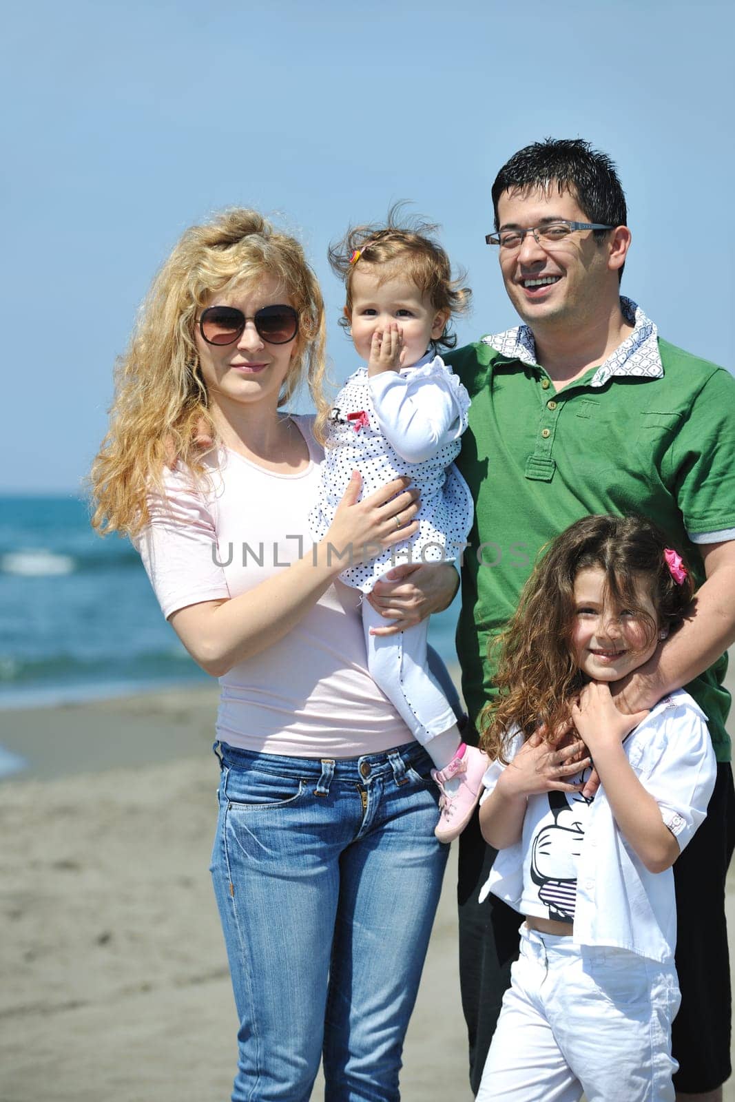 happy young family have fun and live healthy lifestyle on beach