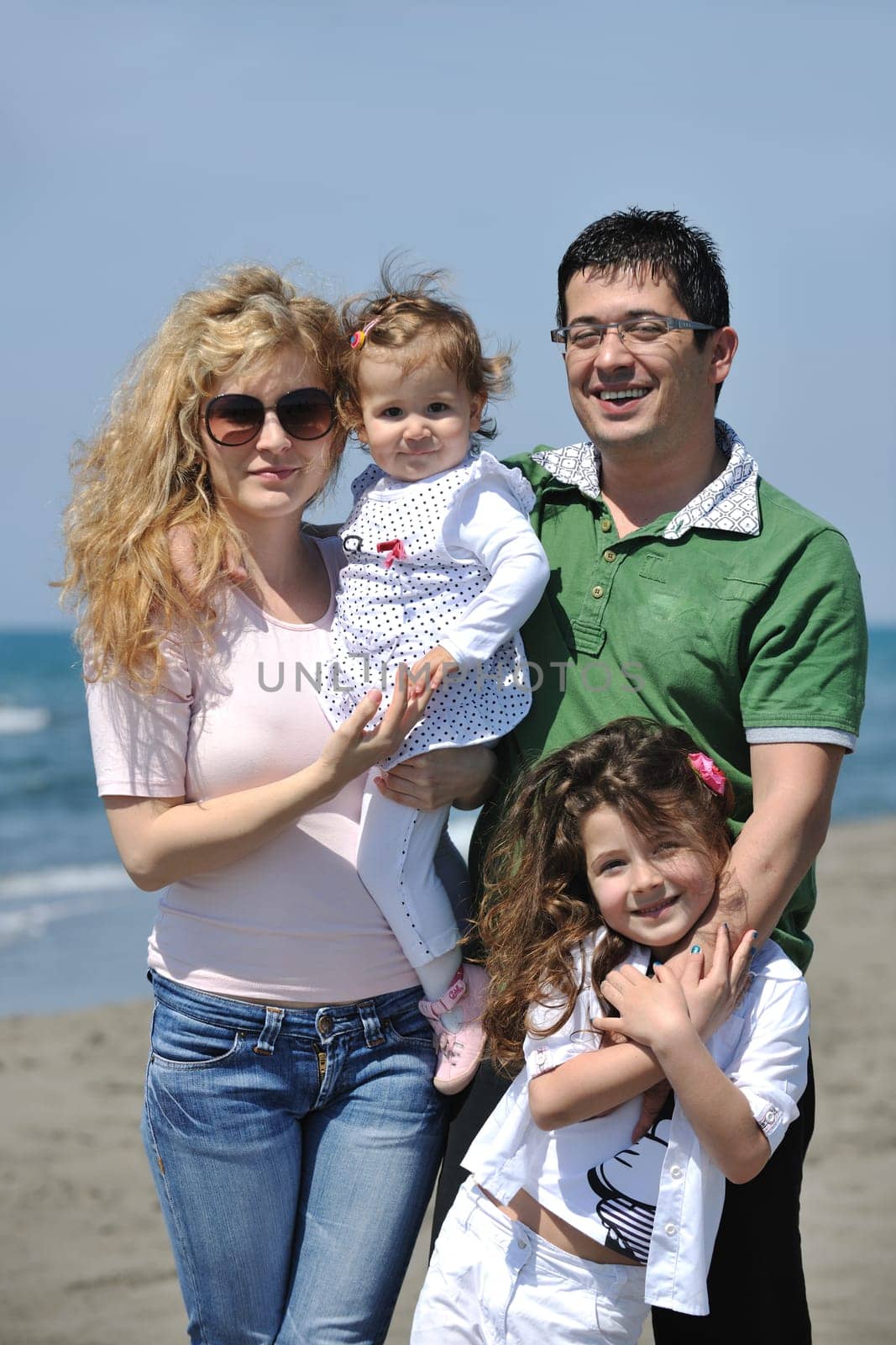 happy young family have fun and live healthy lifestyle on beach
