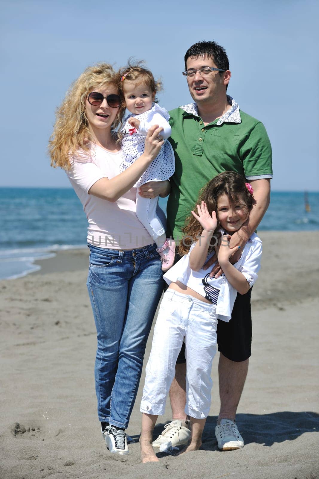 happy young family have fun and live healthy lifestyle on beach