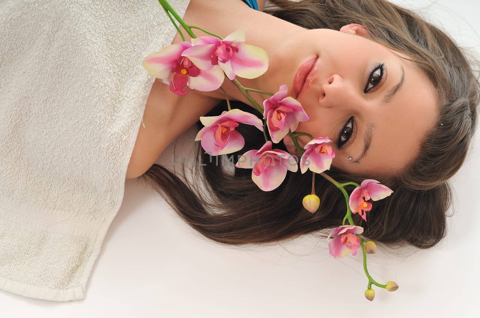 beauty halth and spa wellness isolated young woman face portrait closeup with towel and flower treatment