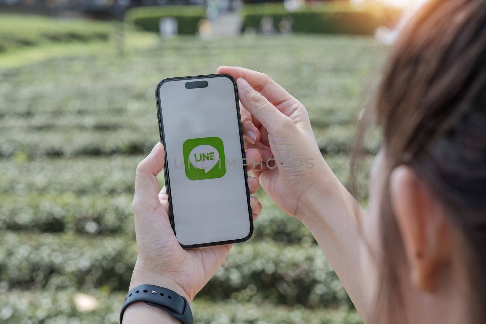 CHIANG MAI, THAILAND - OCT 25 ,2023: Woman holding Apple iPhone 6S with LINE apps on screen. LINE is a new communication app which allows you to make free voice calls and send free messages.