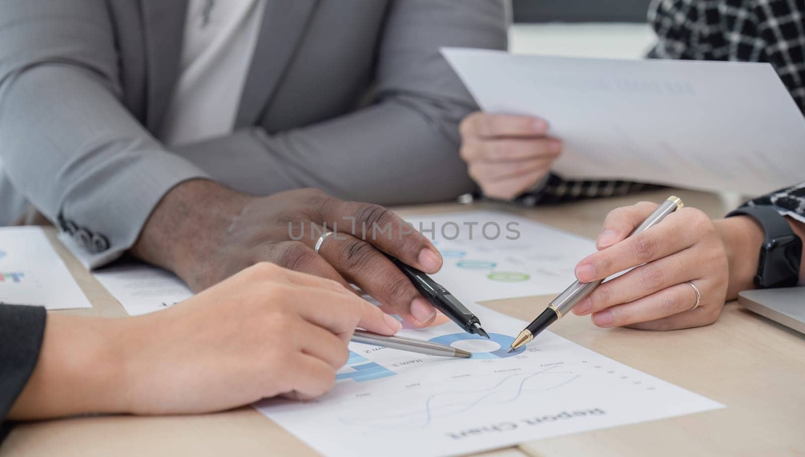 Business People Meeting using laptop computer,calculator,notebook,stock market chart paper for analysis Plans to improve quality next month. Conference Discussion Corporate Concept by wichayada